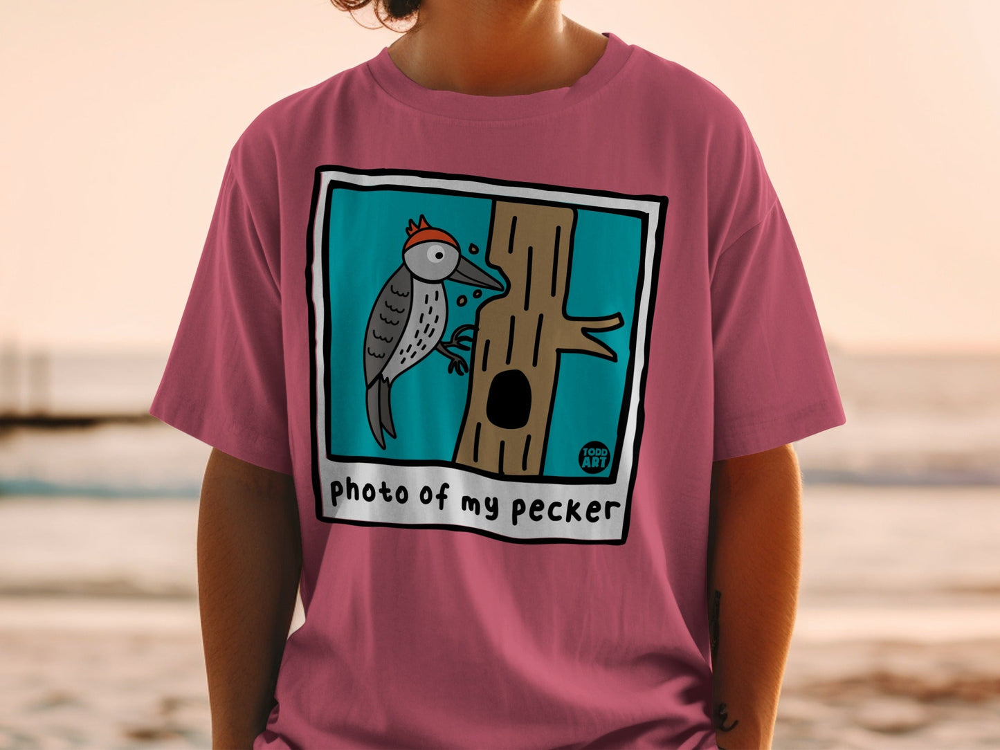 T-shirt with cartoon woodpecker on tree and text "photo of my pecker".