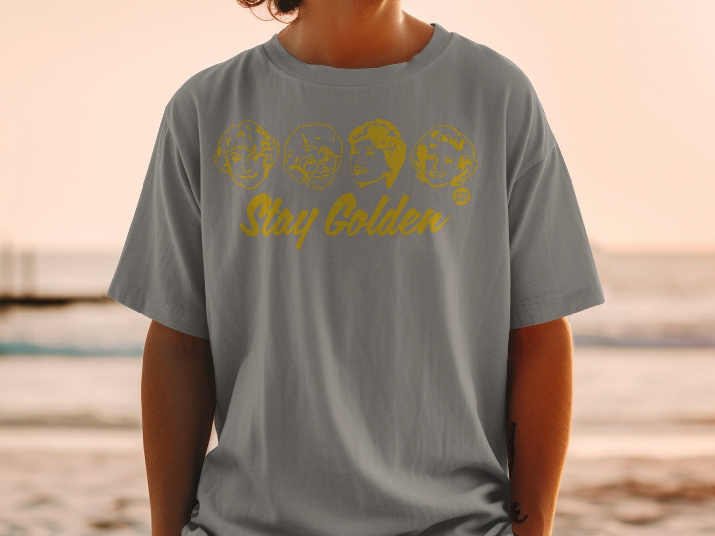 Gray t-shirt with "Stay Golden" and cartoon portraits of The Golden Girls.
