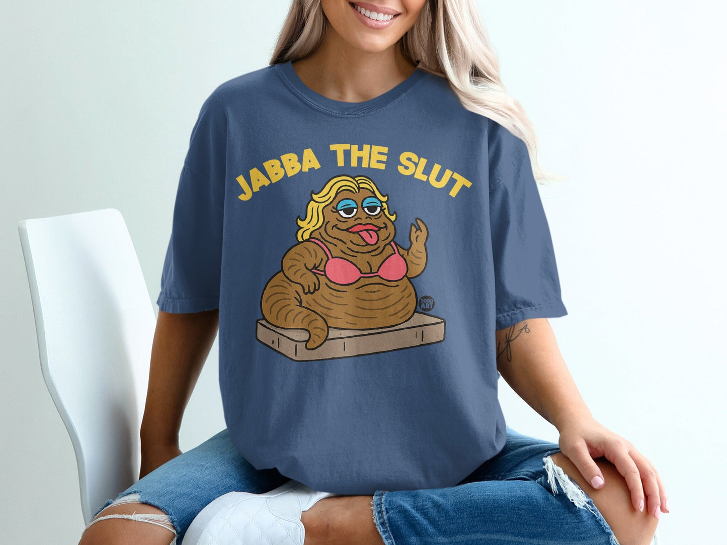 Blue t-shirt with "JABBA THE SLUT" text and cartoon illustration.