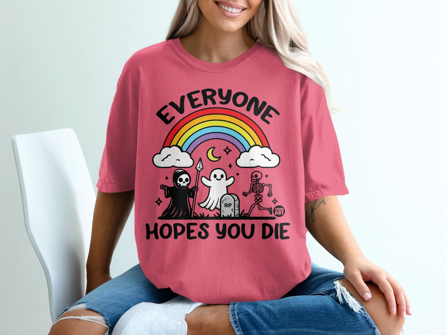 Pink t-shirt with "EVERYONE HOPES YOU DIE" and cartoon grim reaper, ghost, and skeleton.