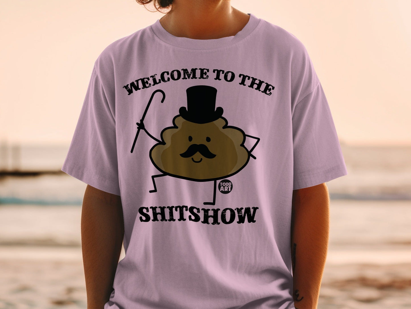 Purple t-shirt with "Welcome to the Shitshow" and a cartoon poop character.