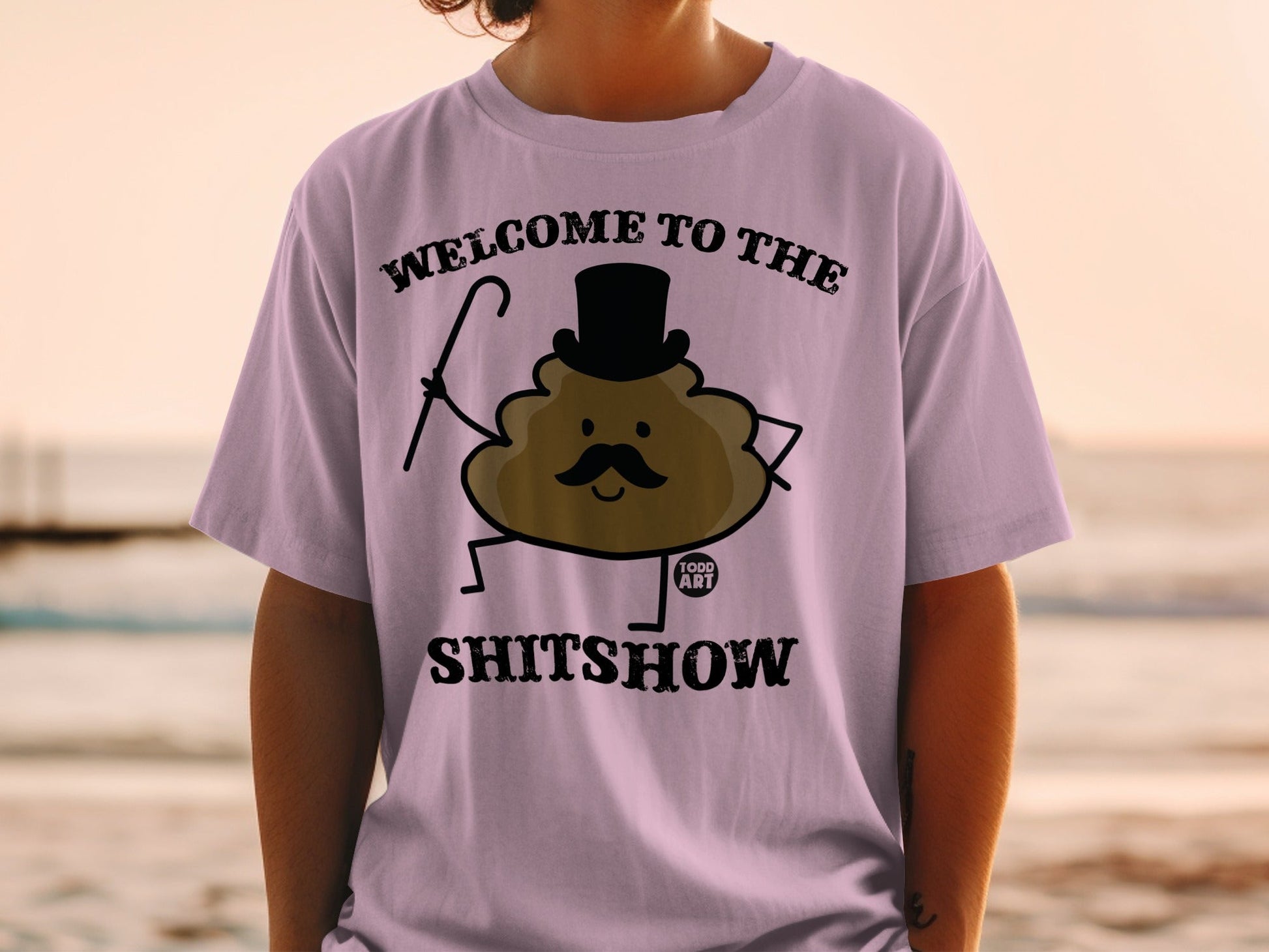 Purple t-shirt with "Welcome to the Shitshow" and a cartoon poop character.