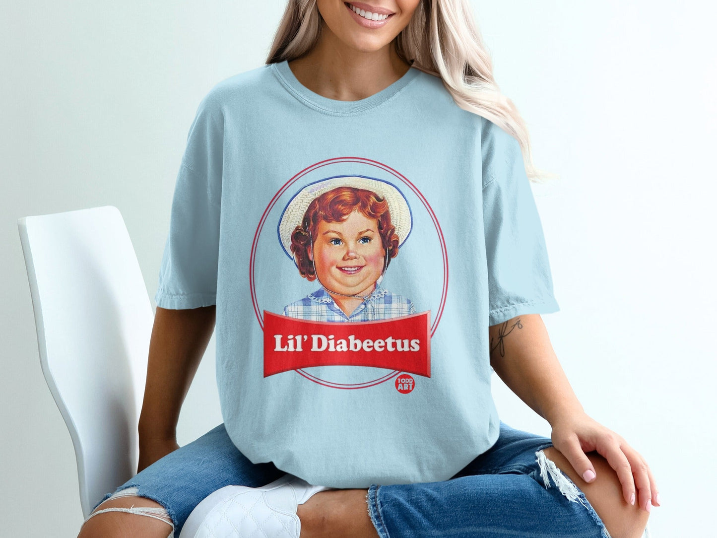 Light blue t-shirt with "Lil' Diabeetus" logo featuring a child's portrait.