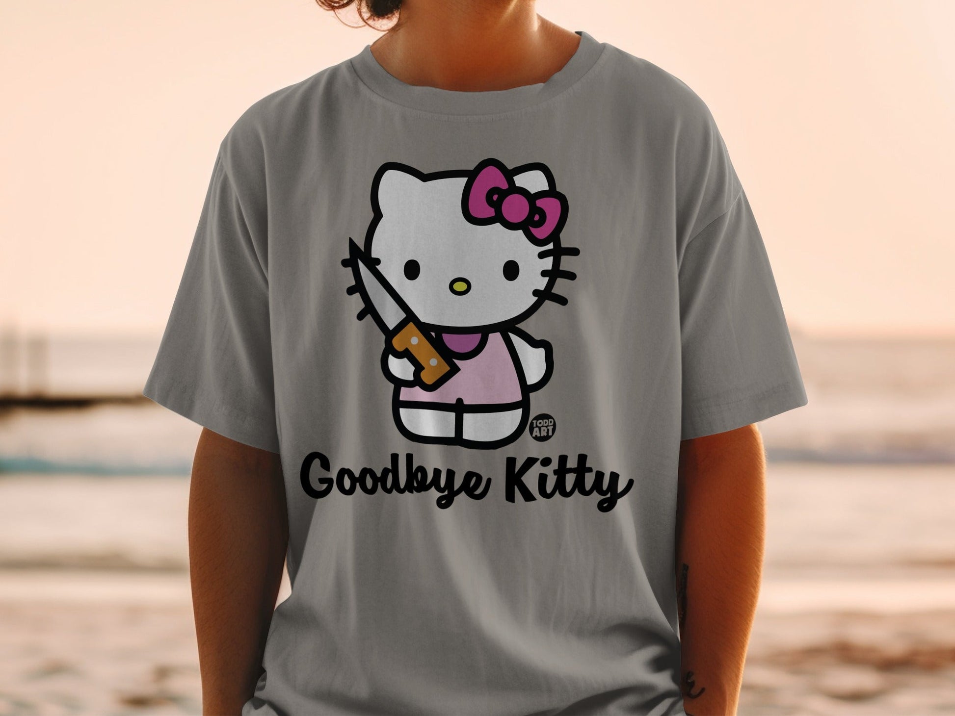Grey t-shirt with Hello Kitty holding a knife and "Goodbye Kitty" text.