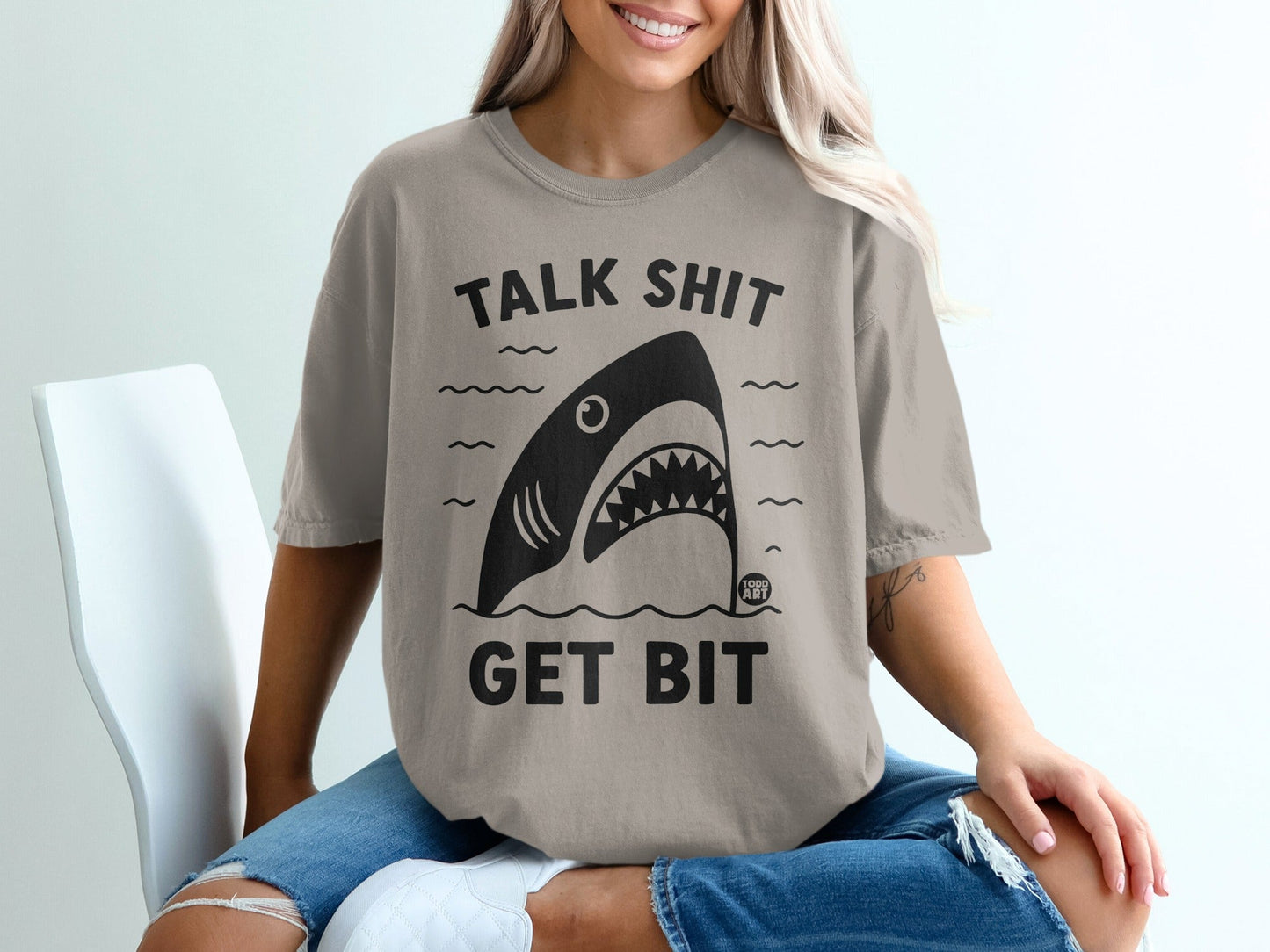 Grey t-shirt with shark graphic and text "TALK SHIT GET BIT".