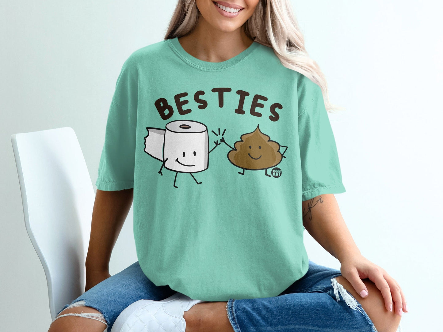 T-shirt with cartoon toilet paper and poop characters holding hands, text "BESTIES" above.