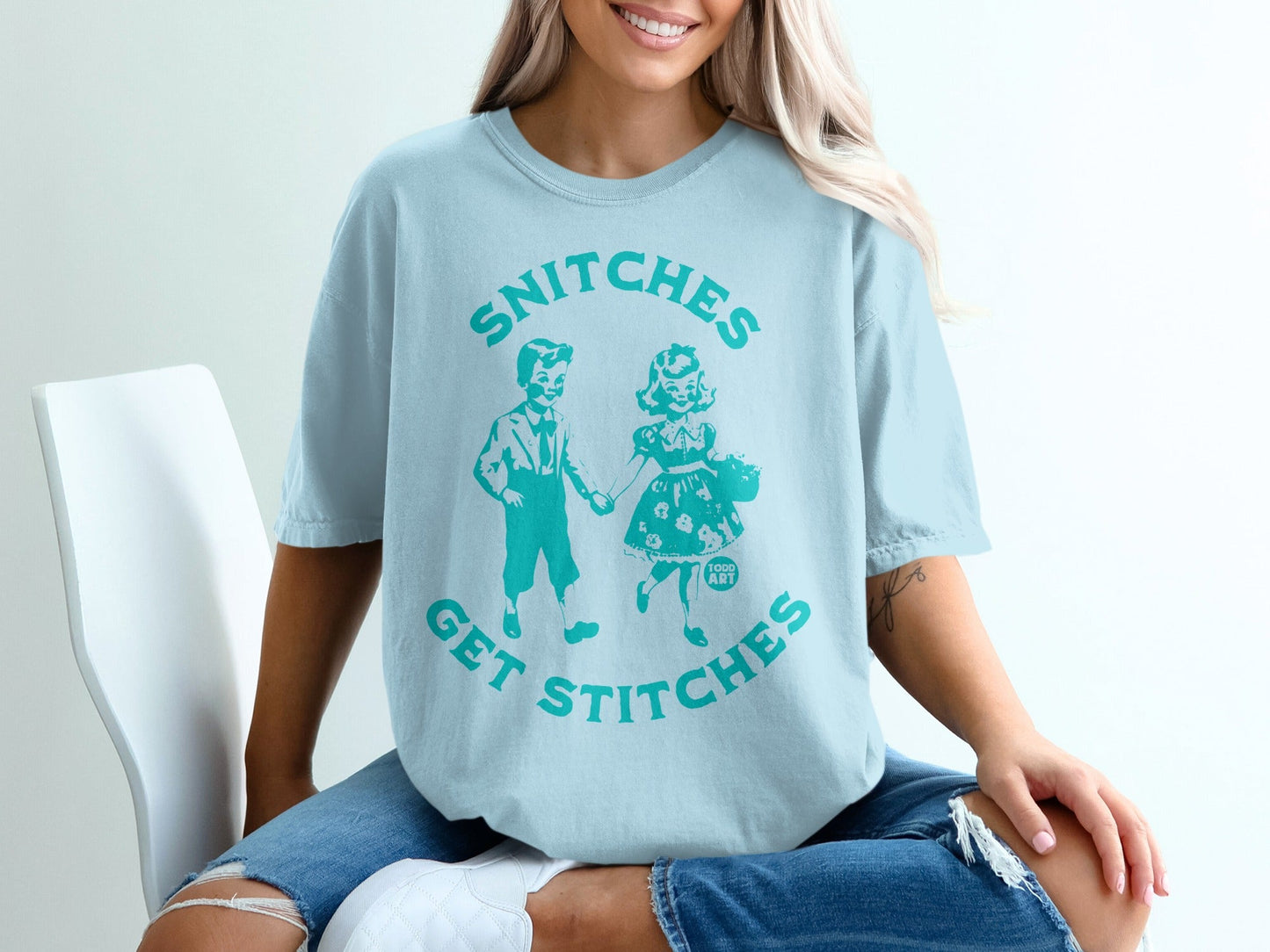 Light blue t-shirt with "SNITCHES GET STITCHES" text and cartoon children graphic.