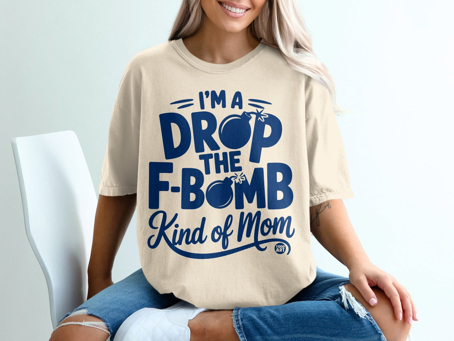 Cream t-shirt with "I'm a drop the F-bomb kind of mom" text.