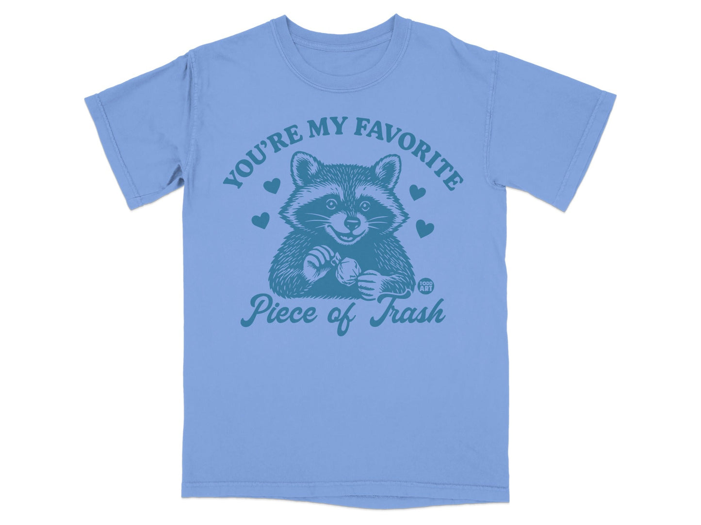 Light blue t-shirt with a raccoon holding a heart that says "You're my favorite piece of trash."