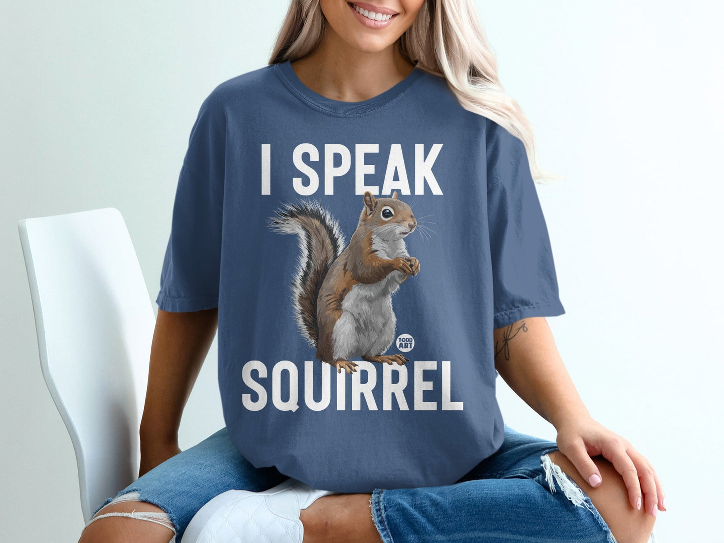 Blue t-shirt with squirrel graphic and "I SPEAK SQUIRREL" text.