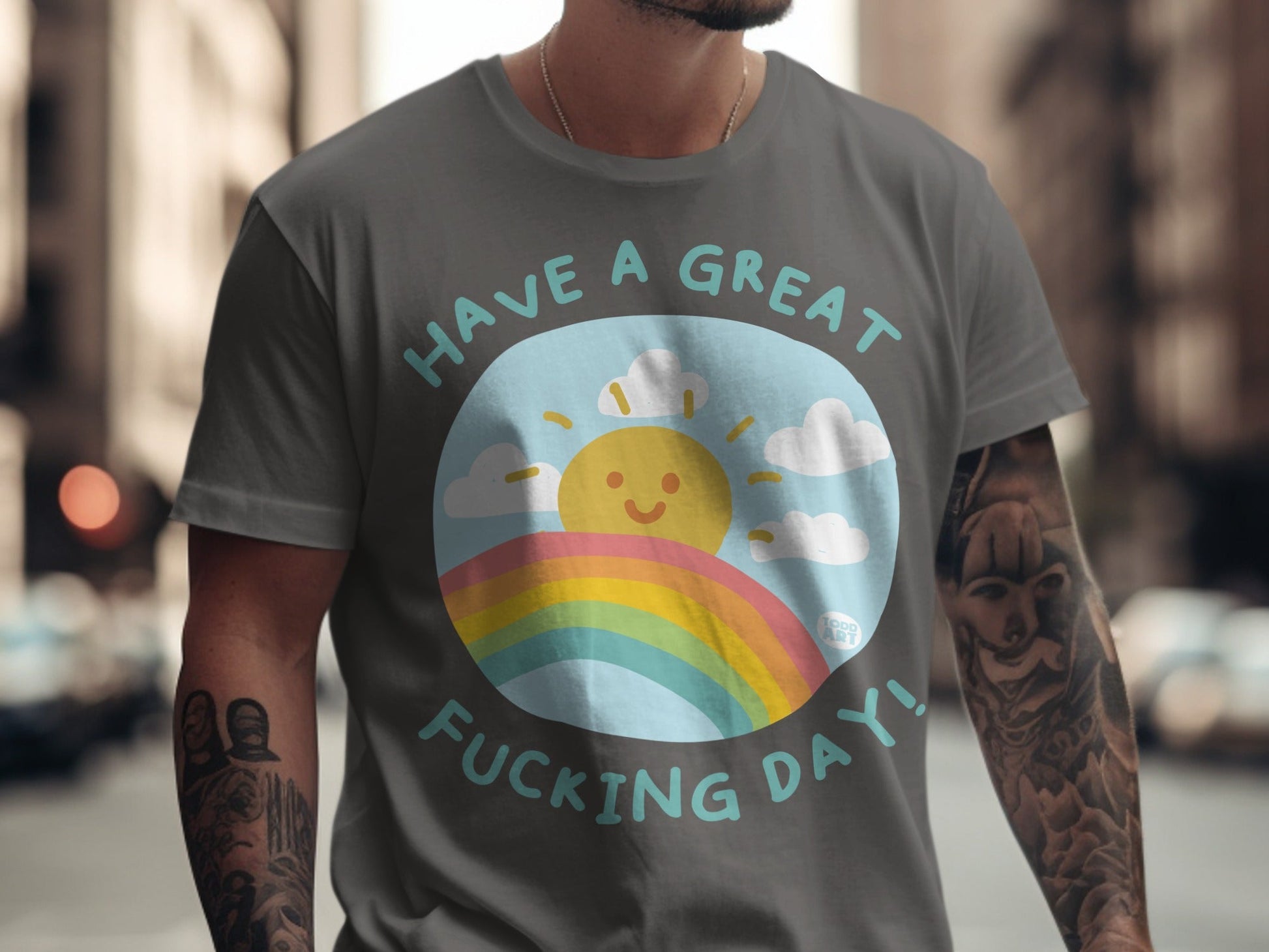 Gray t-shirt with "HAVE A GREAT FUCKING DAY!" and a sun and rainbow graphic.