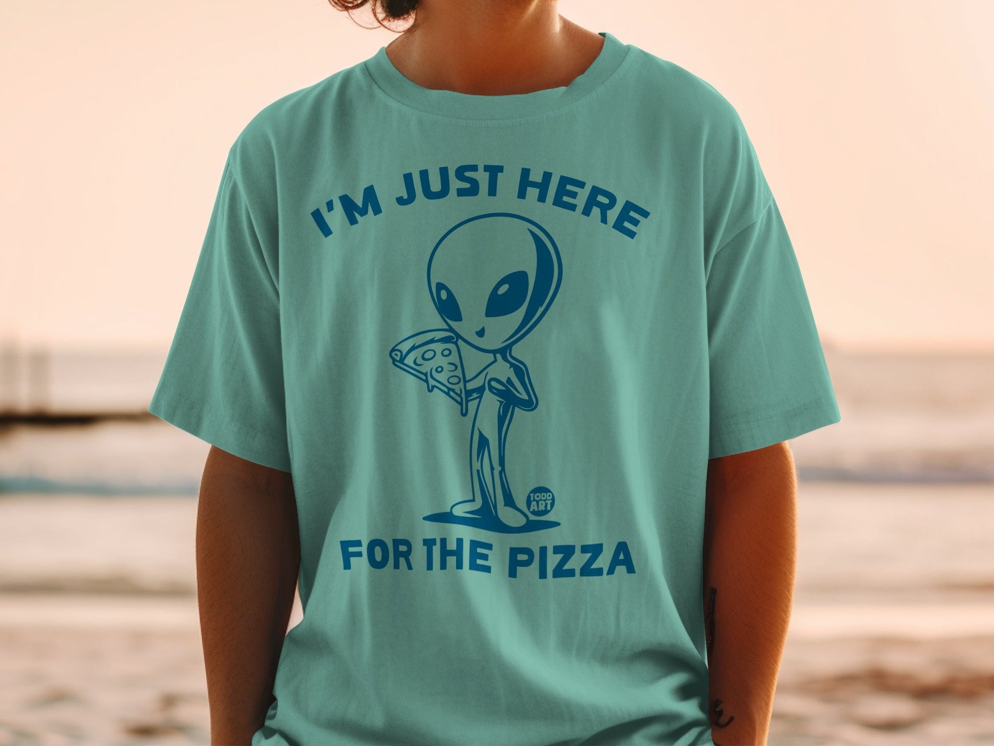 Teal t-shirt with alien holding pizza and text "I'm Just Here For The Pizza".
