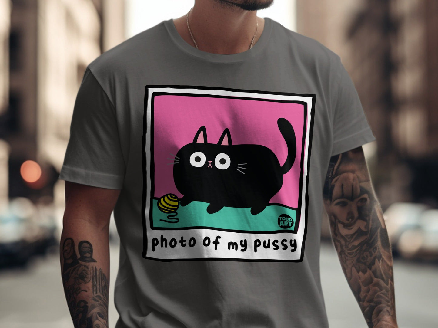 Black cartoon cat with yarn ball on pink background, text "photo of my pussy".
