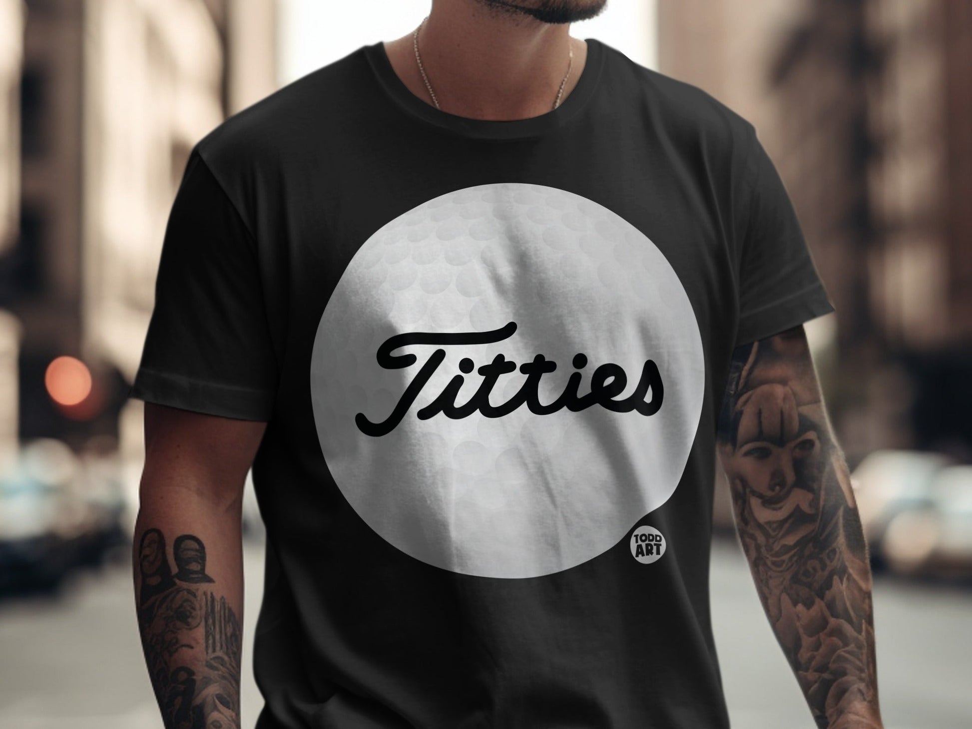 Black t-shirt with a large white golf ball featuring "Todd Art" text.