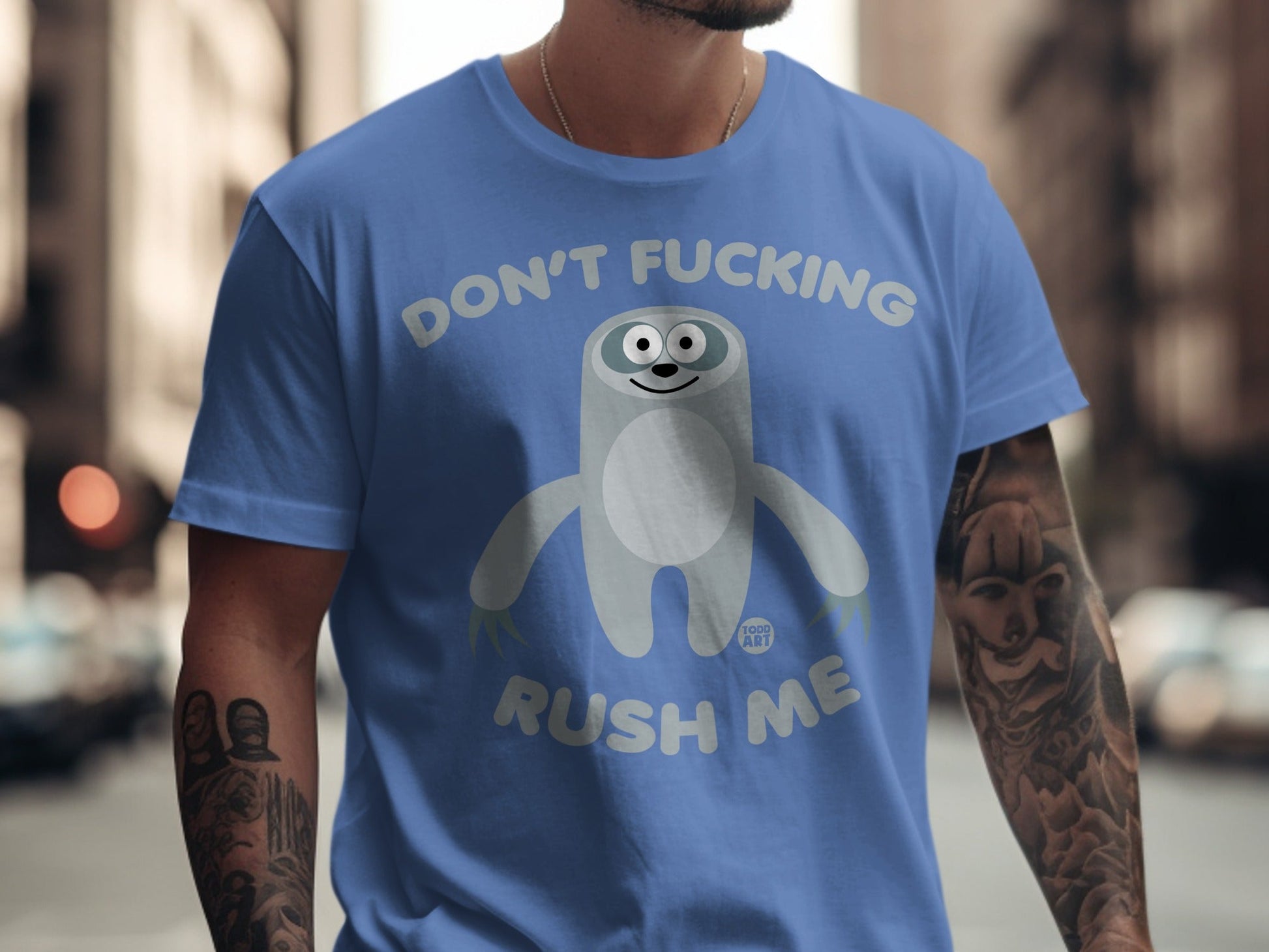 Blue t-shirt with cartoon sloth and text "DON'T FUCKING RUSH ME".