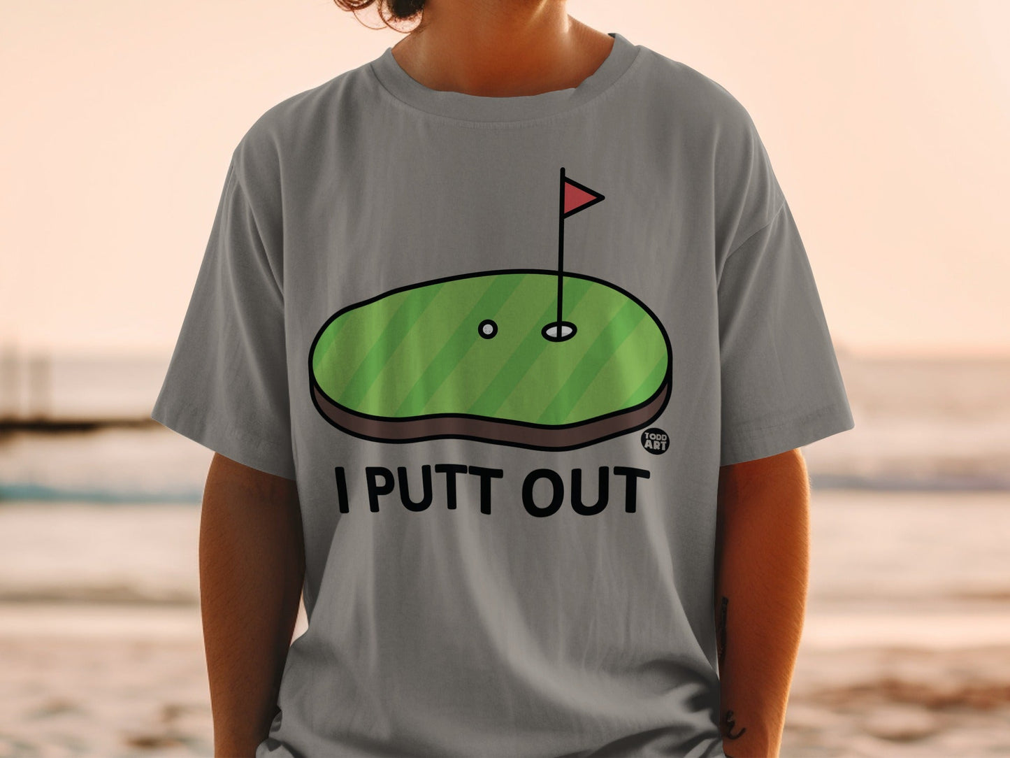 Grey t-shirt with "I PUTT OUT" and a golf hole graphic.