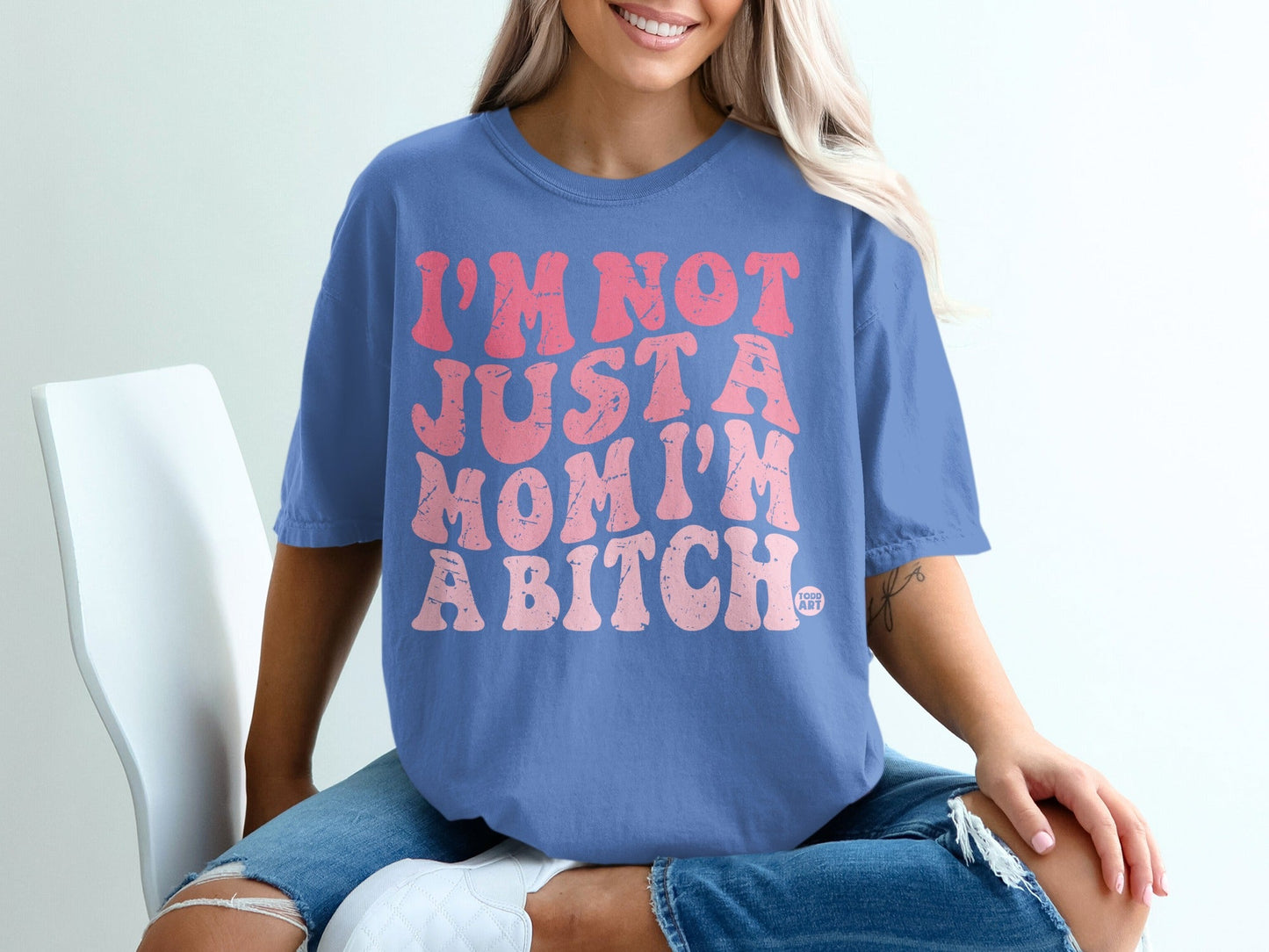 Blue t-shirt with pink text that reads "I'm not just a mom I'm a bitch".