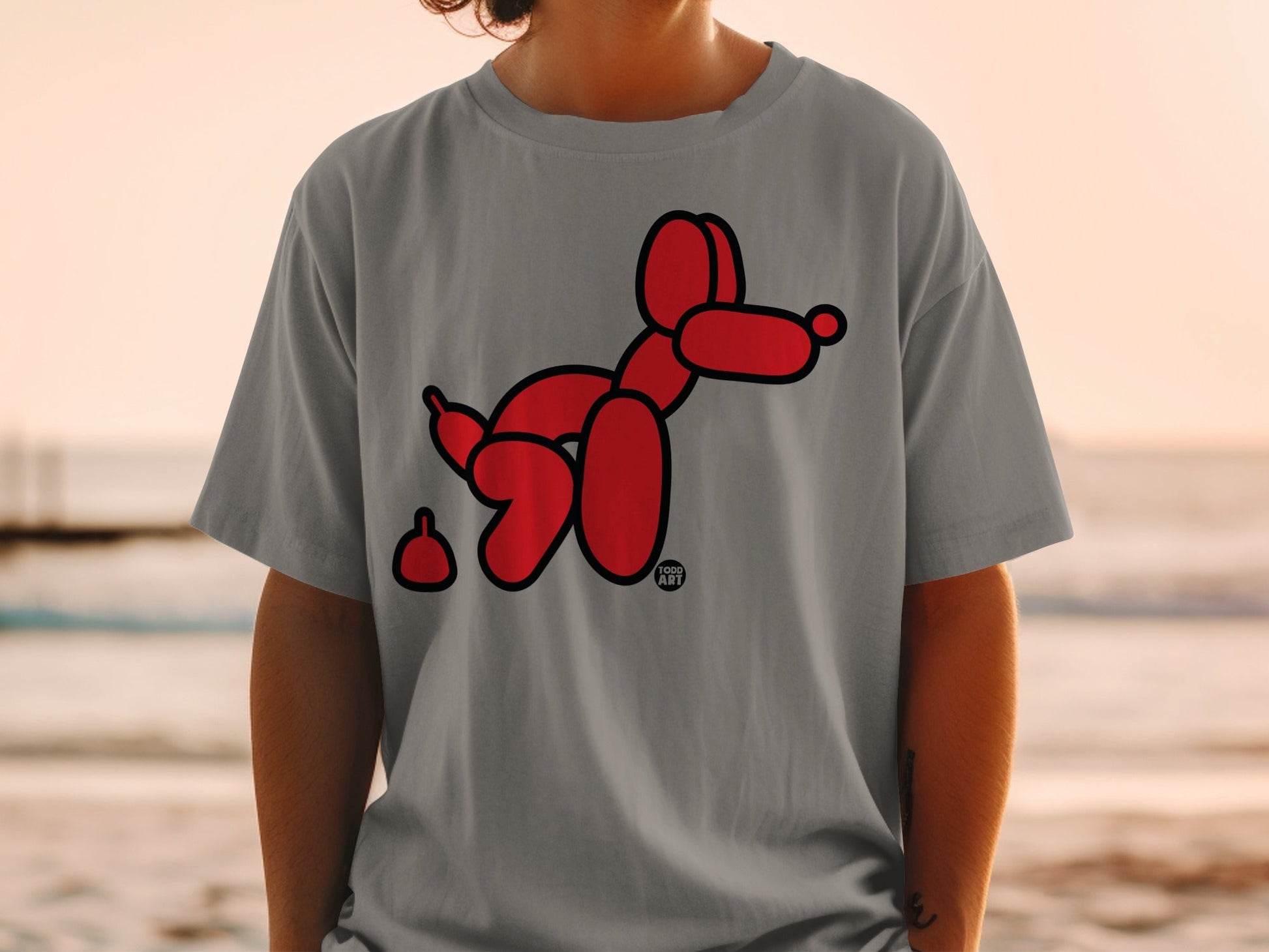 Red balloon dog graphic with "GOOD ART" logo on gray t-shirt.