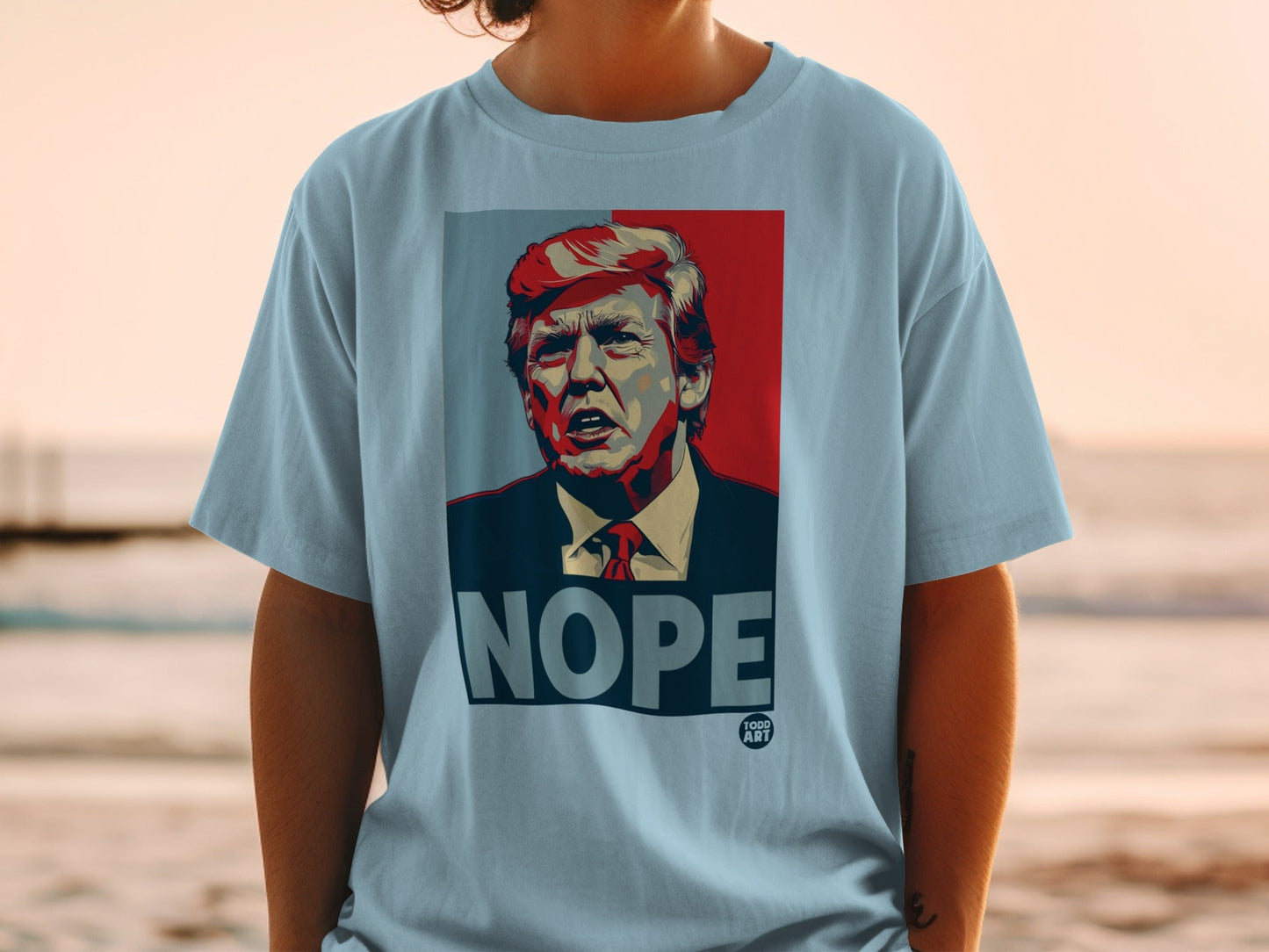 Light blue t-shirt with Donald Trump portrait and "NOPE" text.