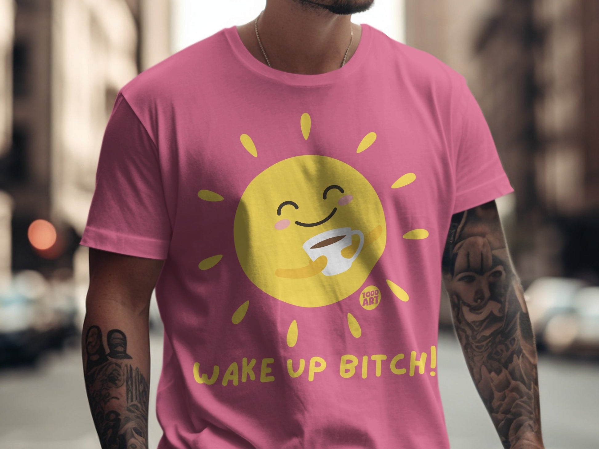 Pink t-shirt with a cartoon sun holding coffee, "Wake Up Bitch!" text.