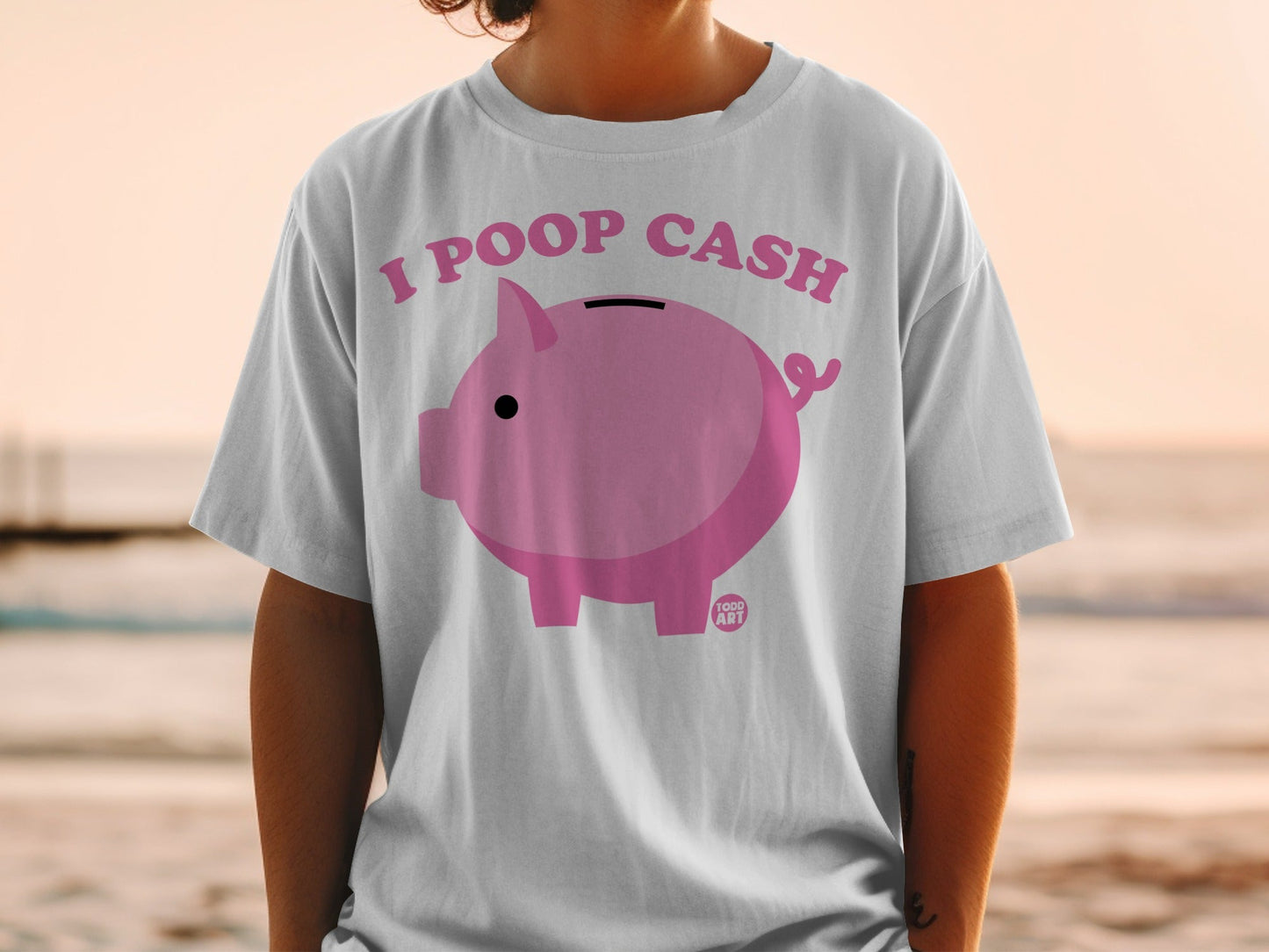White t-shirt with pink piggy bank graphic and "I POOP CASH" text.