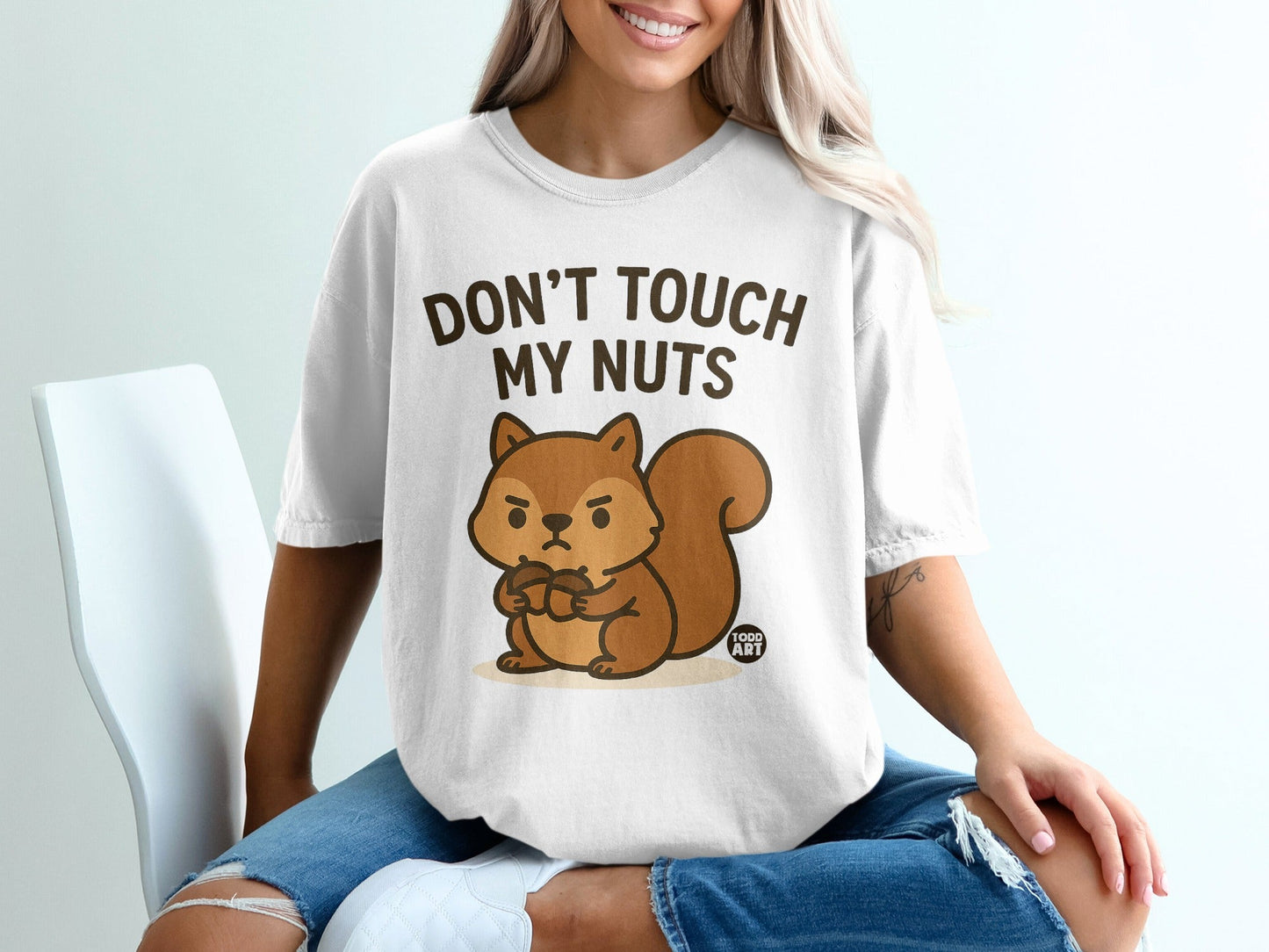 T-shirt with a cartoon squirrel holding acorns and text "Don't Touch My Nuts".