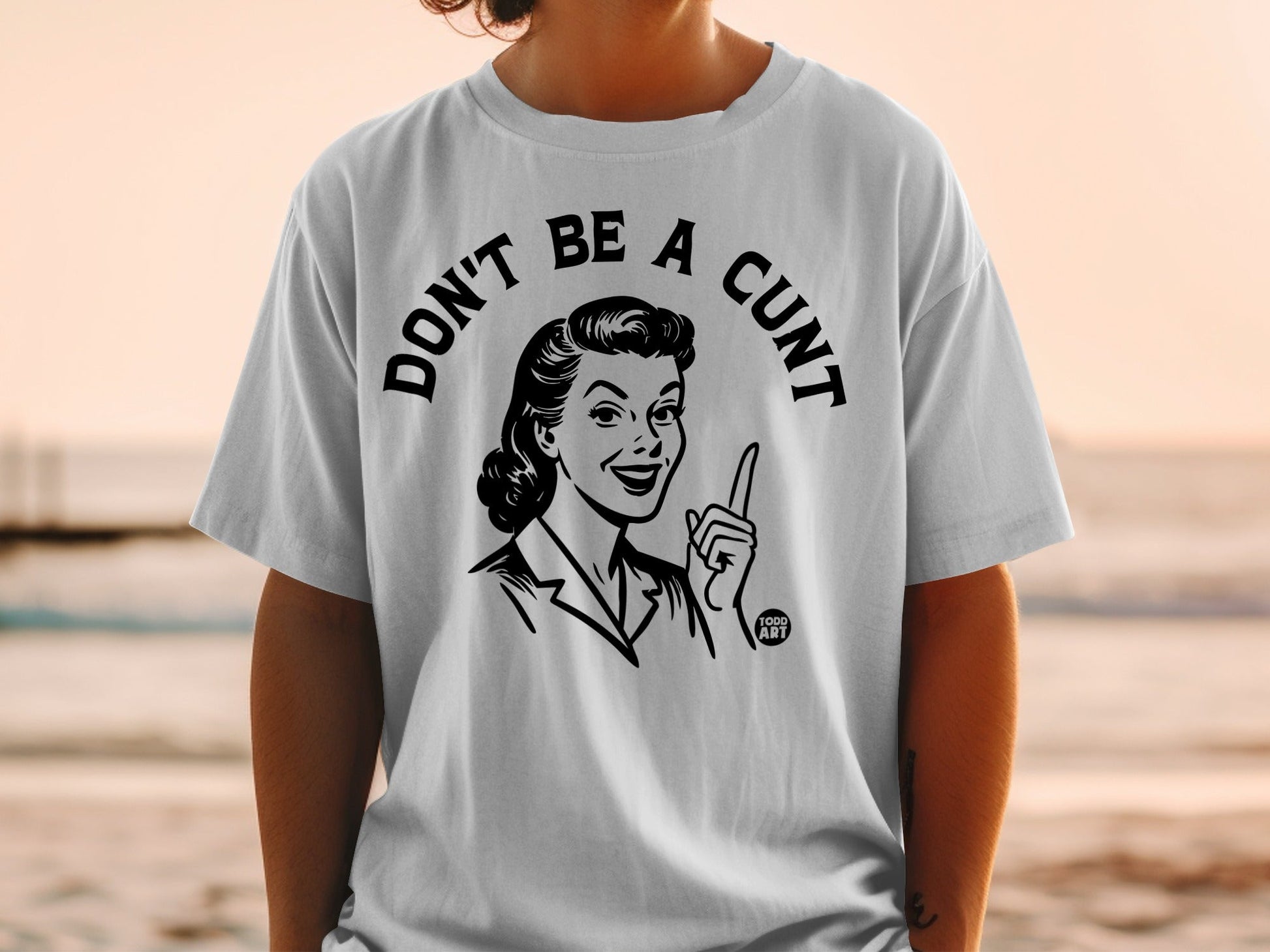 T-shirt with graphic of a retro woman saying "DON'T BE A CUNT".
