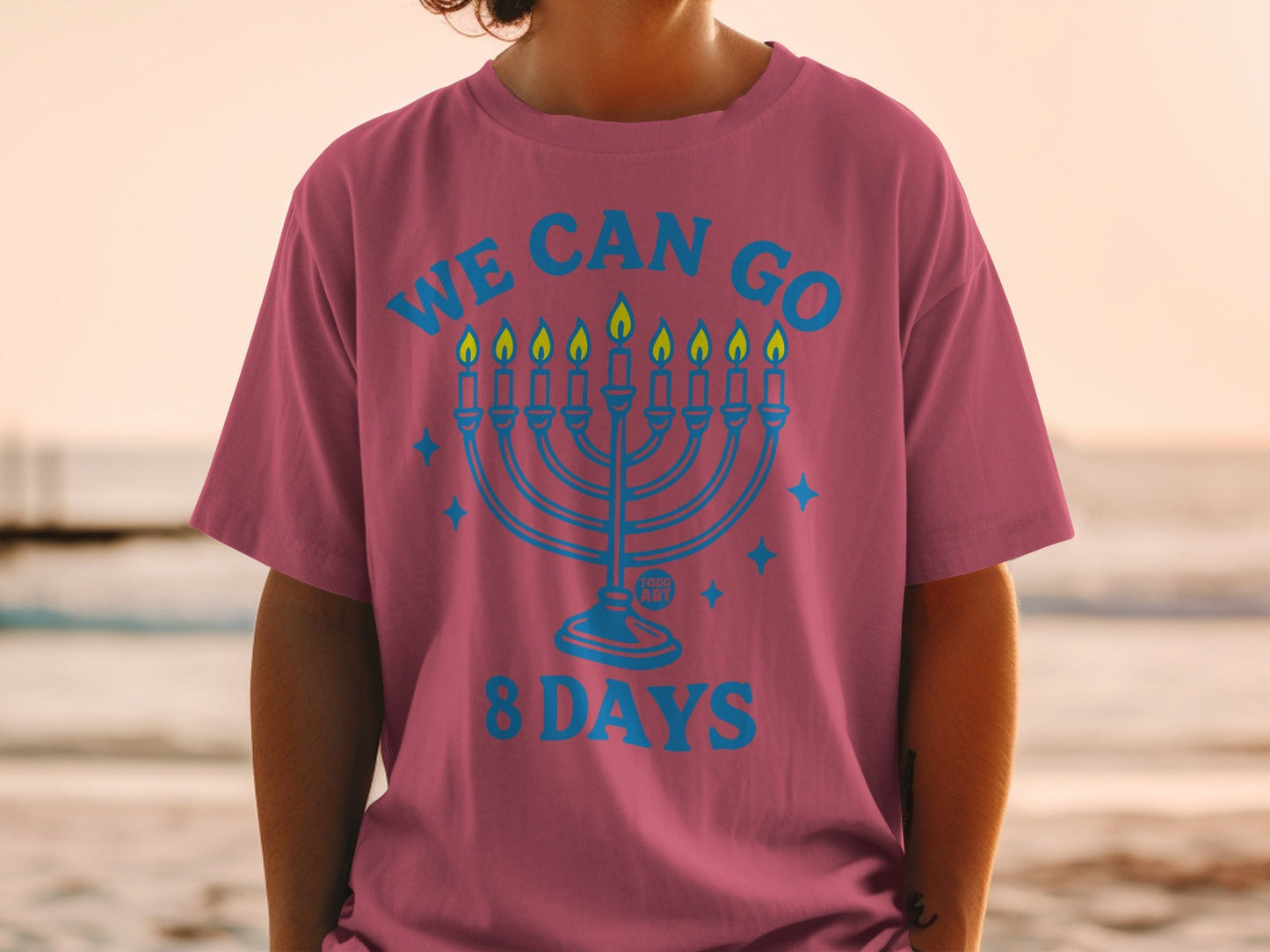 Menorah graphic with "We Can Go 8 Days" text on a maroon t-shirt.