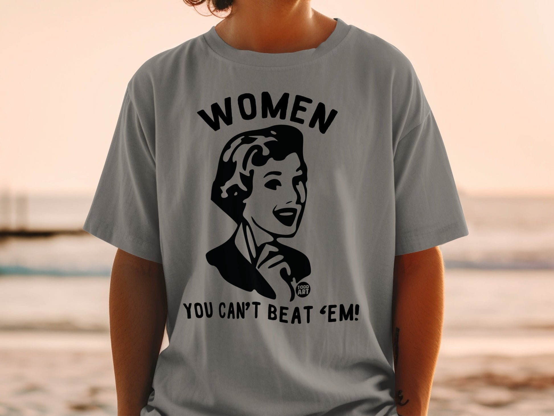 Gray t-shirt with black graphic "WOMEN YOU CAN'T BEAT 'EM!".