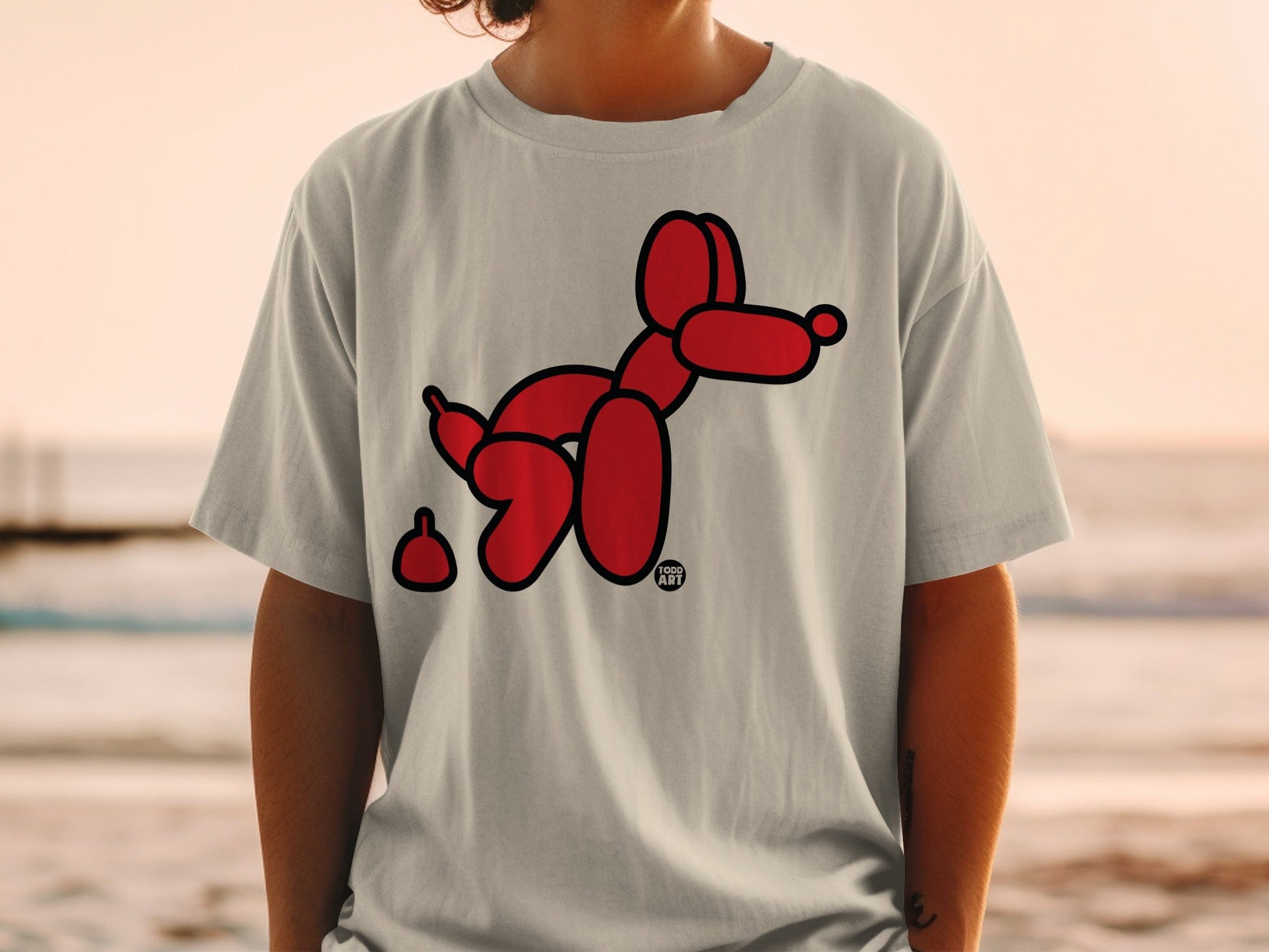 Red balloon dog with a brown poop.