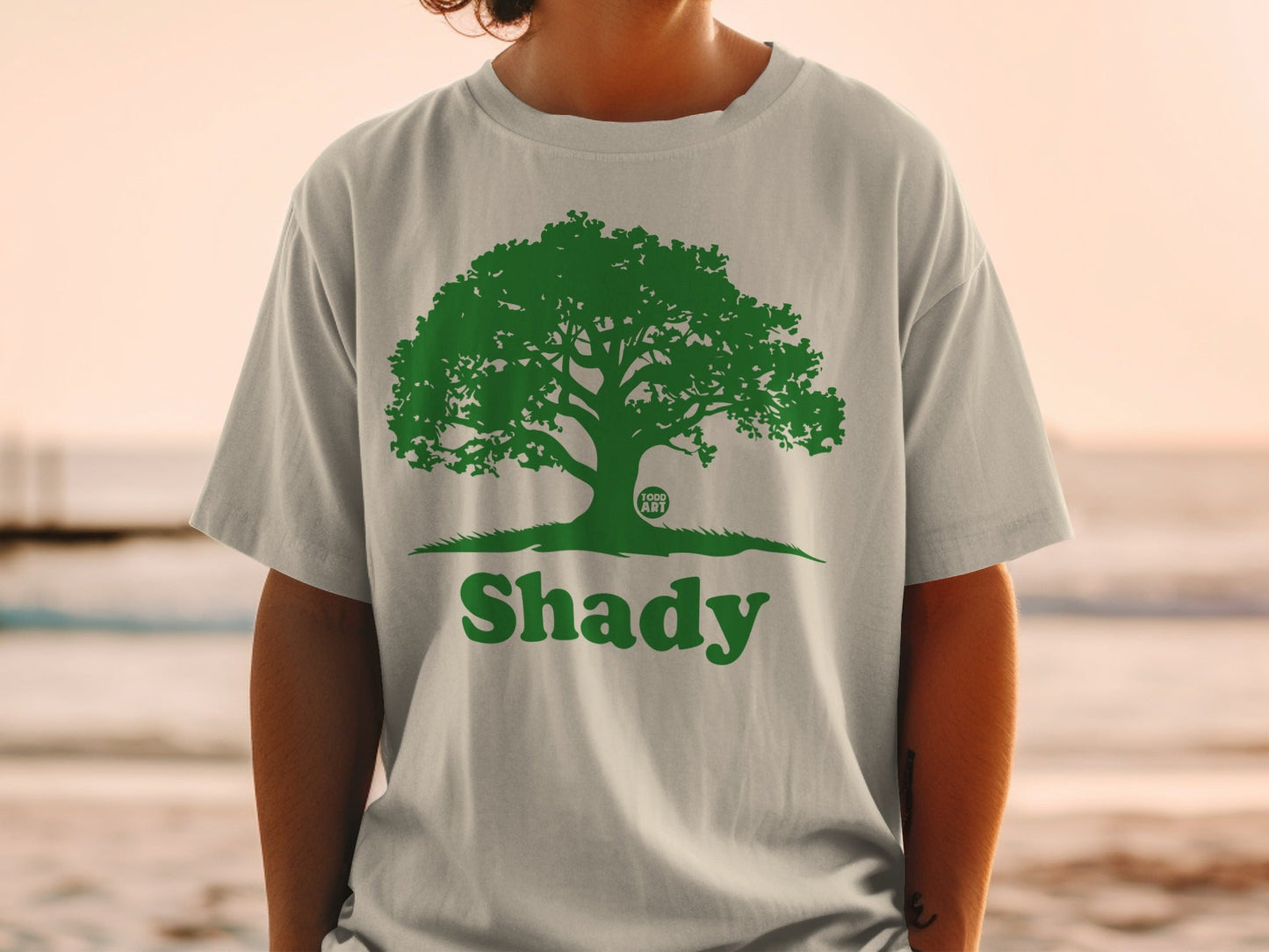 Gray t-shirt with green tree logo and "Shady" text.