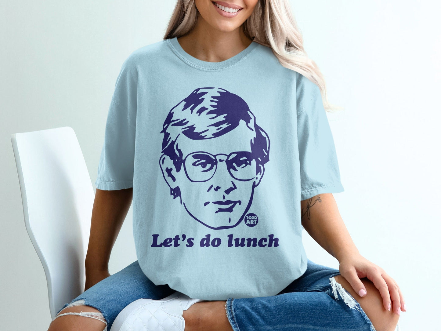 Light blue t-shirt with a graphic of a man's face and the text "Let's do lunch".