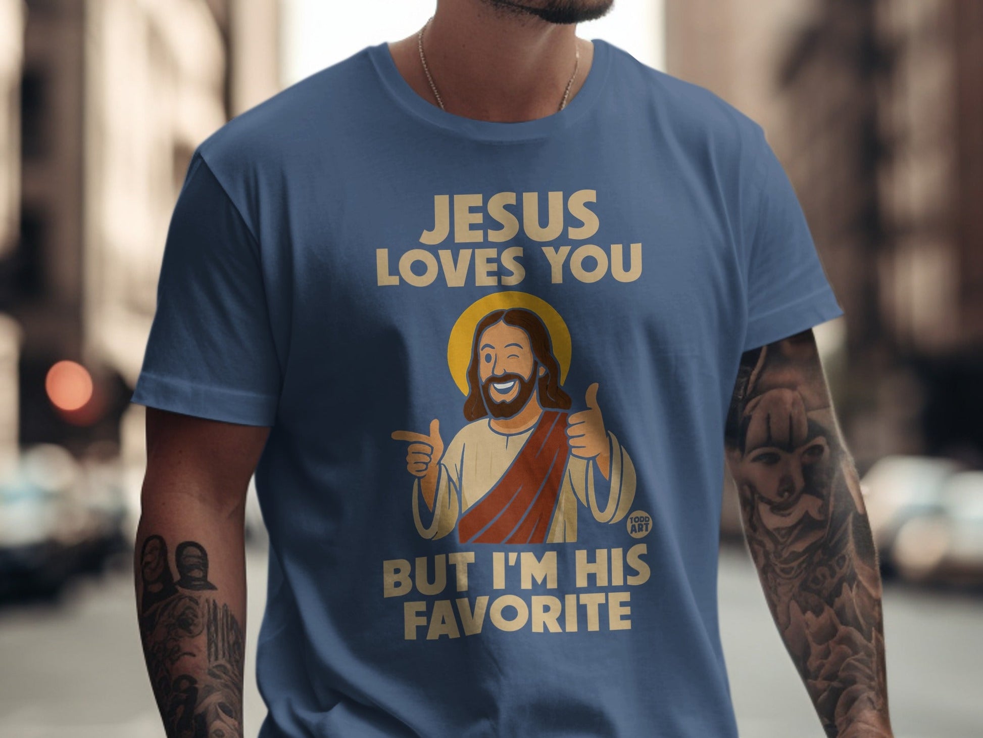 Blue t-shirt with "JESUS LOVES YOU BUT I'M HIS FAVORITE" and Jesus graphic.