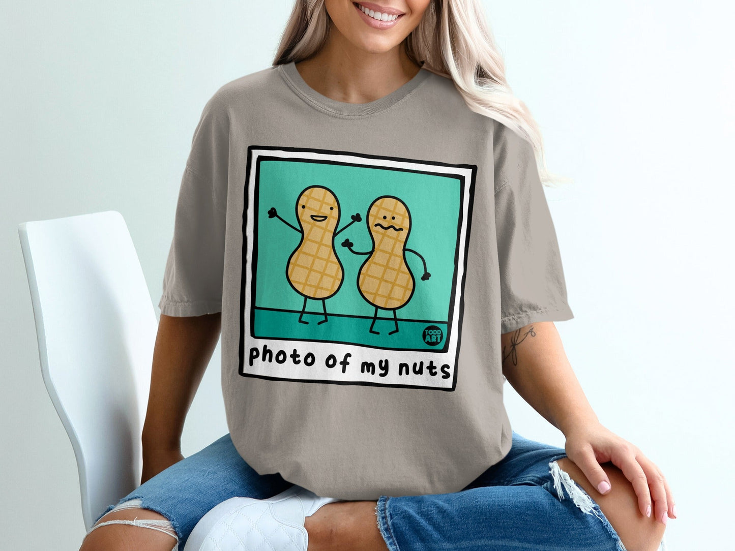 Two cartoon peanuts with arms raised, text reads "photo of my nuts."