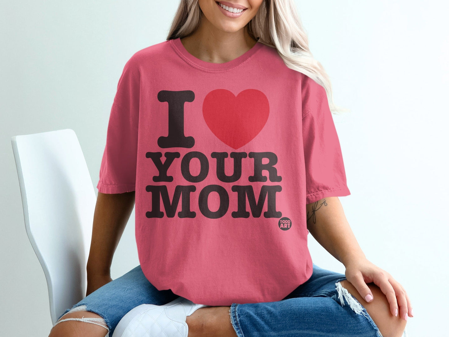 Pink t-shirt with "I ‚ù§Ô∏è YOUR MOM" text and small "TODD ART" logo.