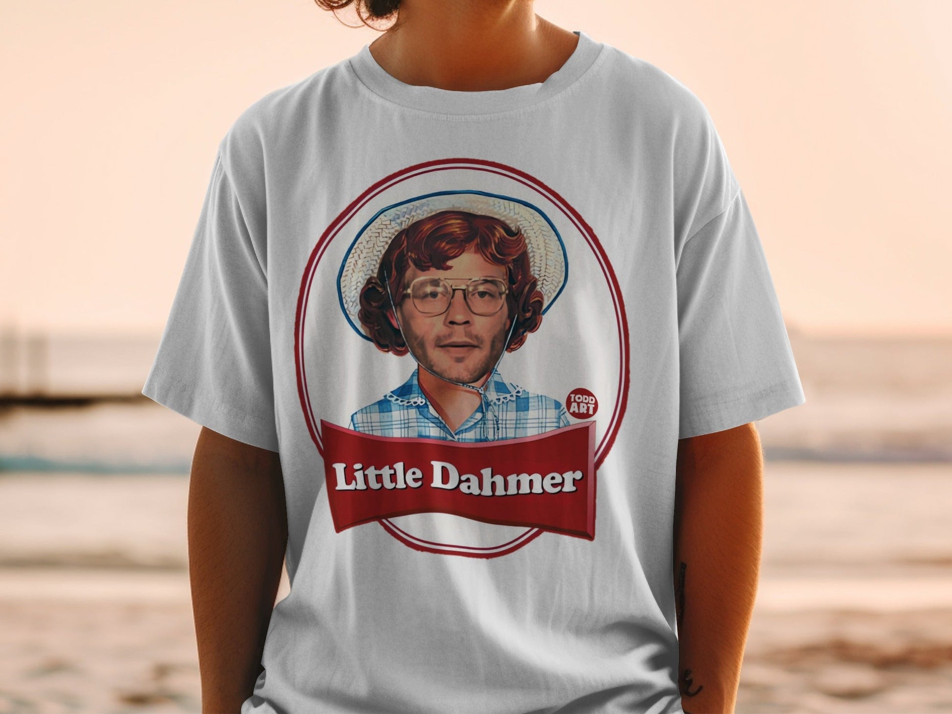 T-shirt featuring a portrait of a man with glasses and a hat, labeled "Little Dahmer".