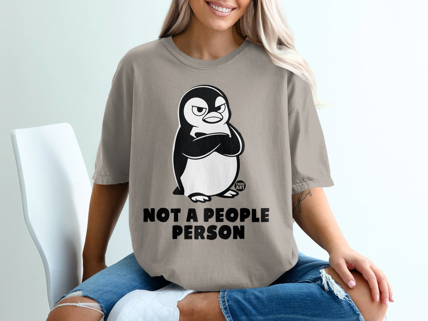 T-shirt with grumpy penguin graphic and "NOT A PEOPLE PERSON" text.
