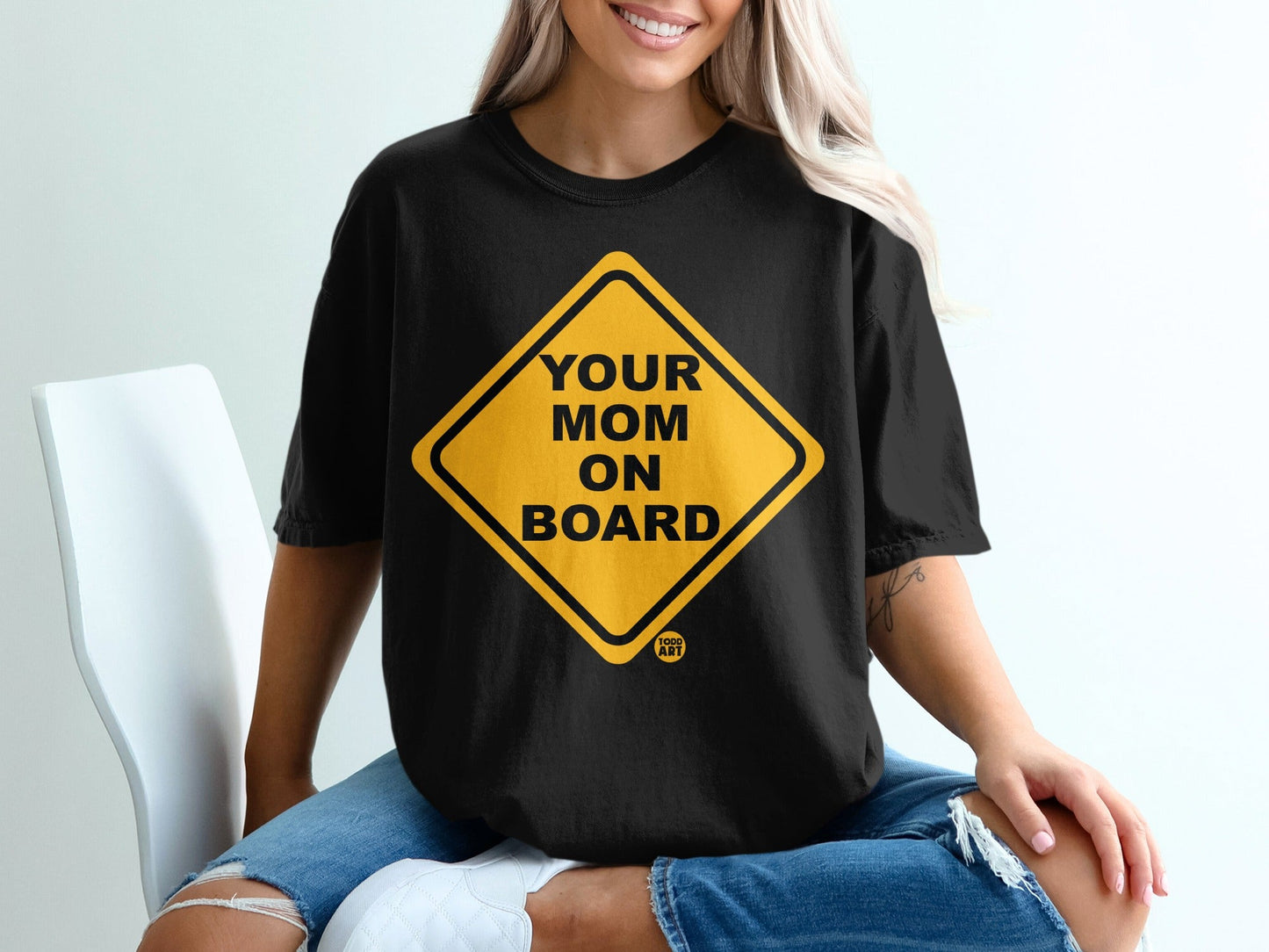 Black t-shirt with yellow diamond-shaped sign reading "Your Mom on Board" and a small logo.