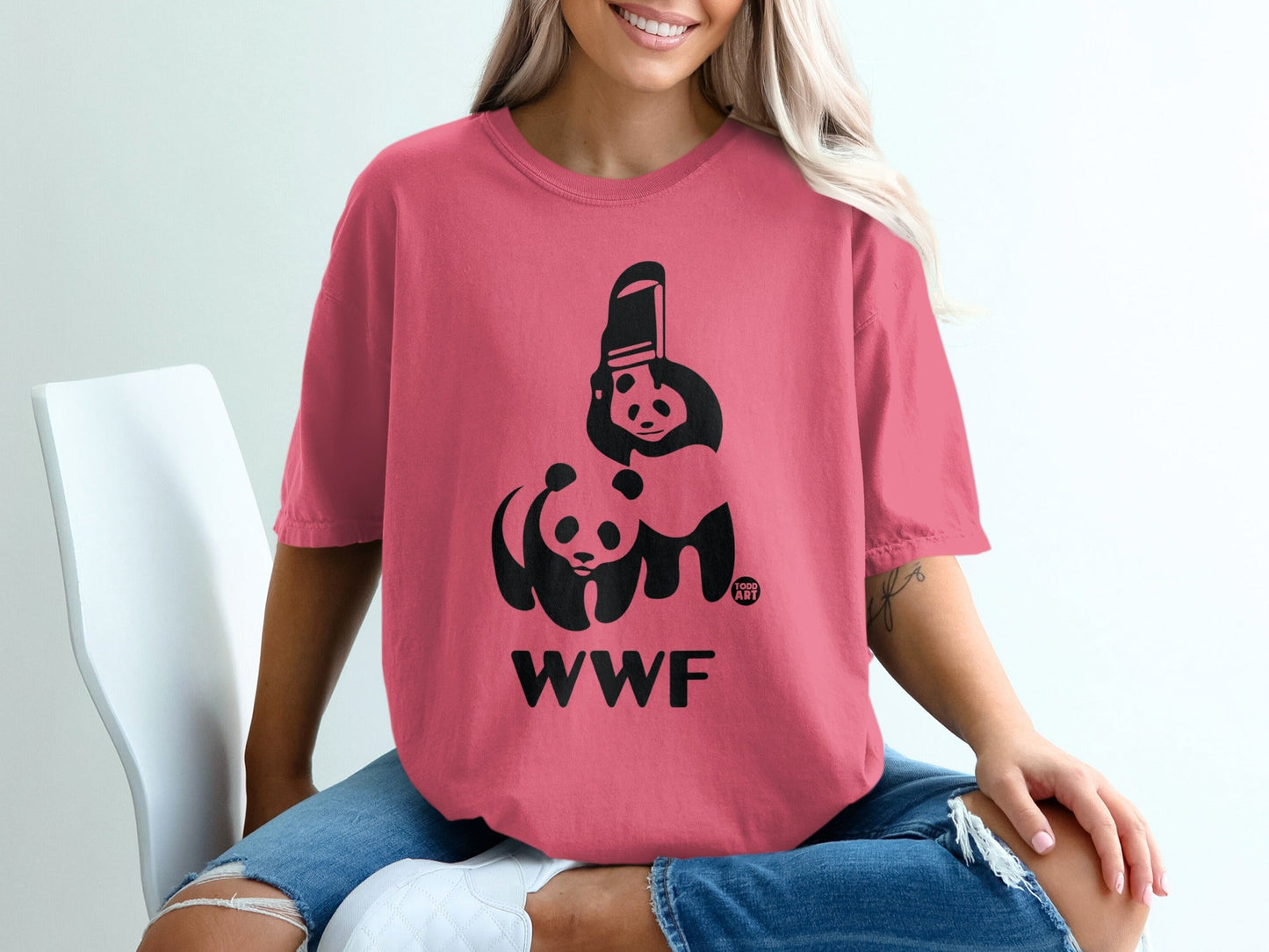 Pink t-shirt with WWF panda logo and "GOOD ART" on the sleeve.