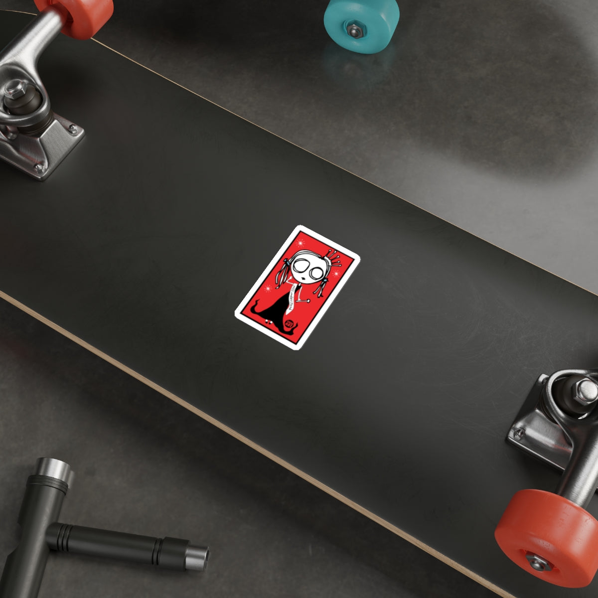 Spooky Cartoon Sticker on Black Skateboard Deck