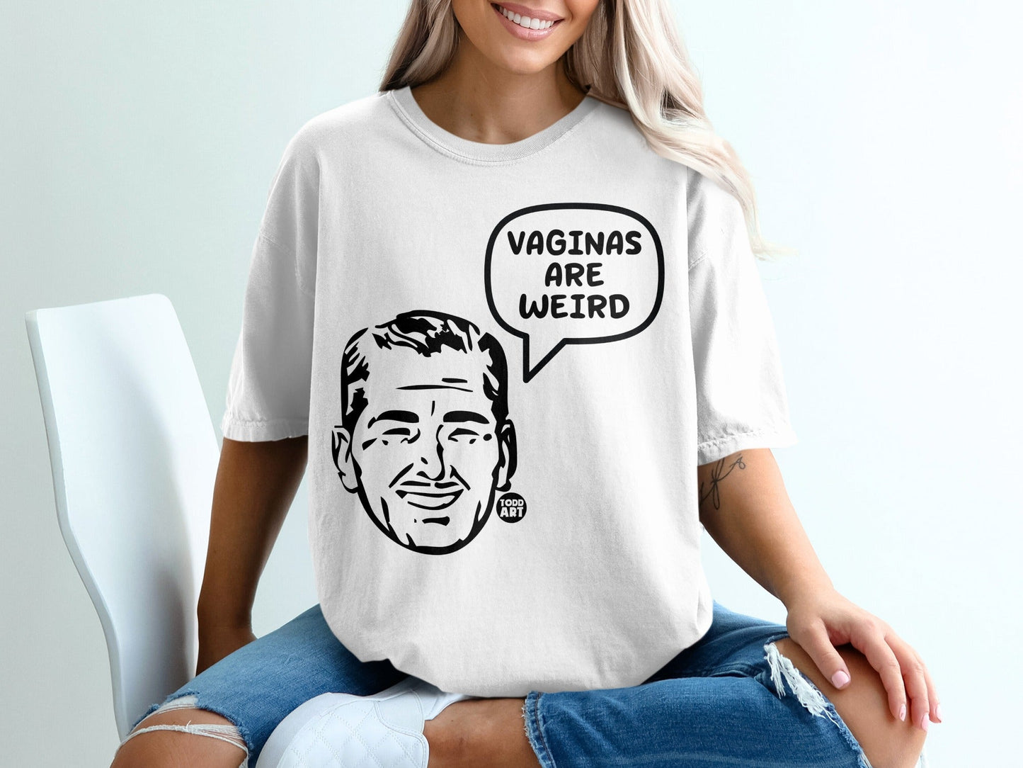 White t-shirt with a graphic of a man's head in a speech bubble saying "VAGINAS ARE WEIRD".
