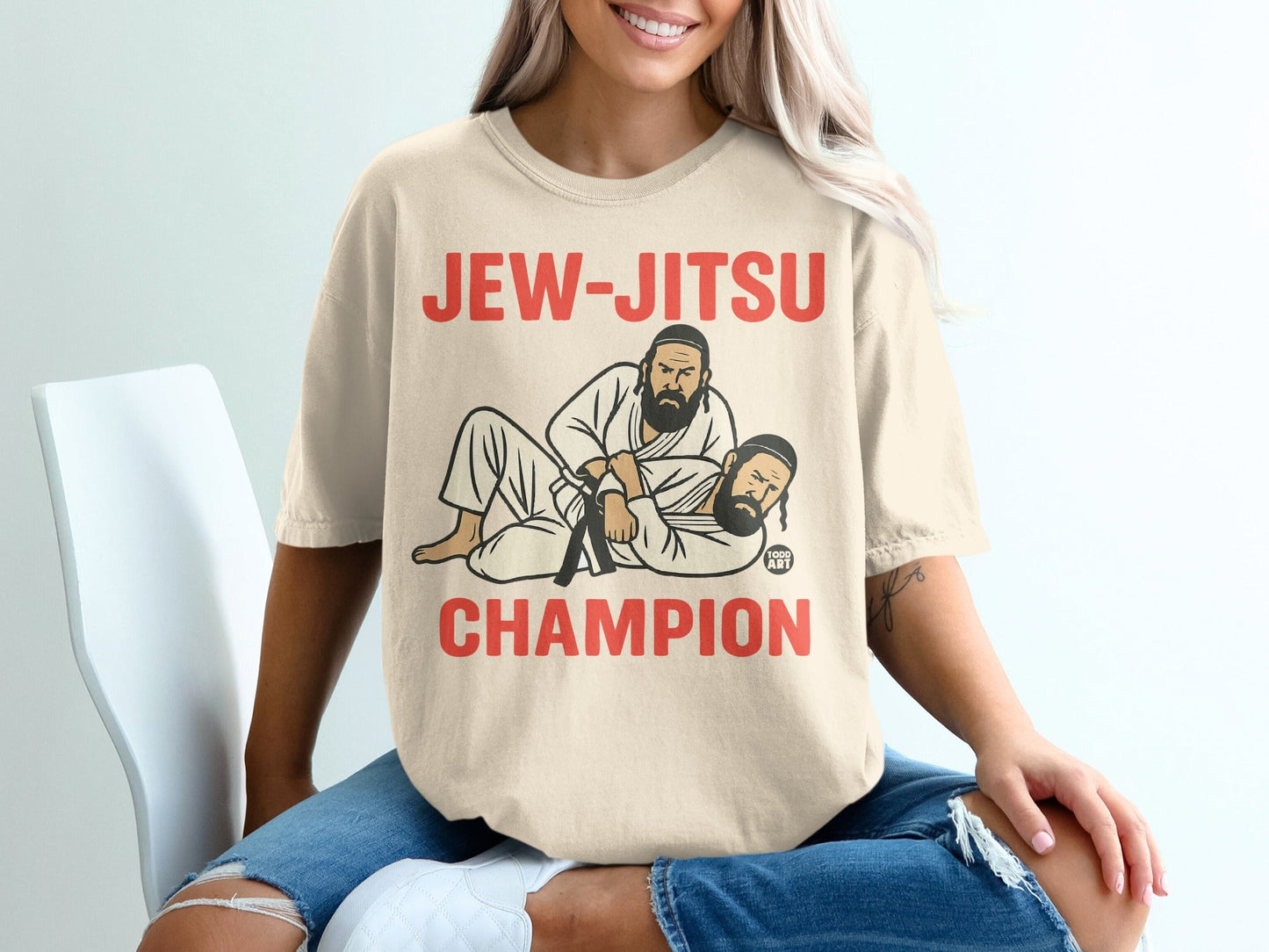 Jew-Jitsu Champion graphic on a tan t-shirt with a dark belt.
