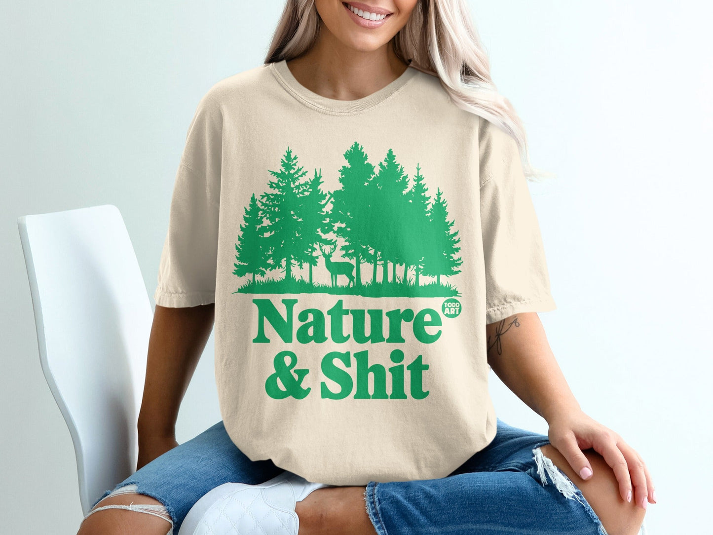 T-shirt with green pine trees and deer graphic, "Nature & Shit" text.