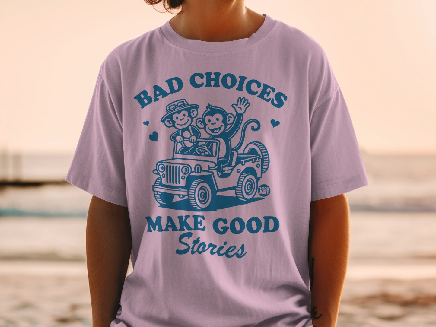 T-shirt graphic with monkeys in a jeep saying "Bad Choices Make Good Stories."