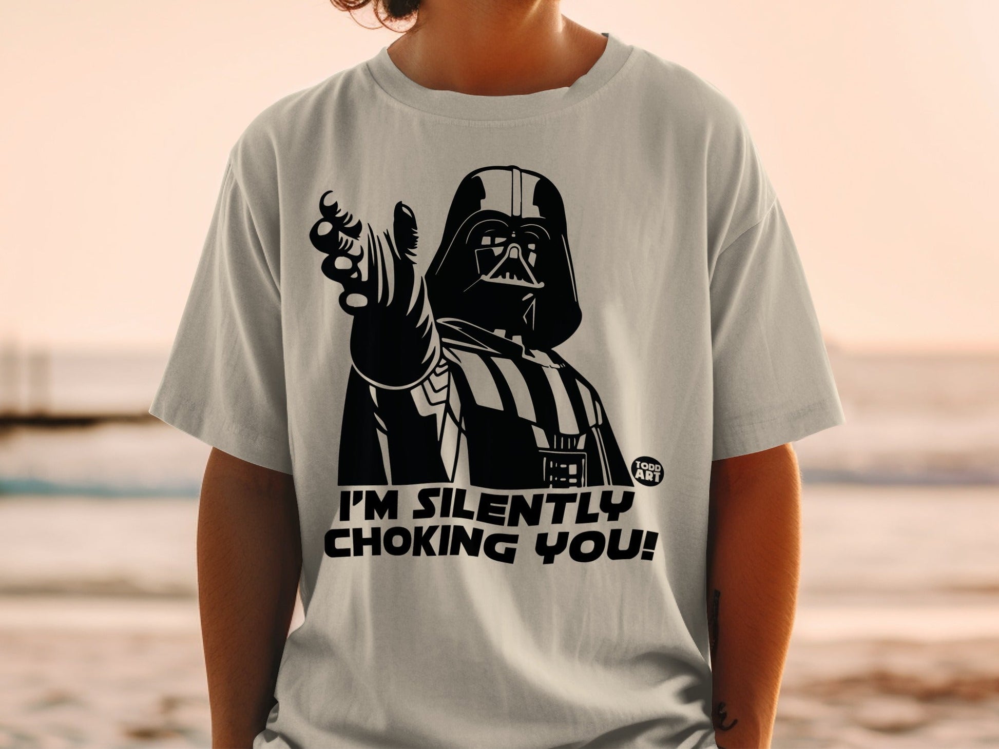 Darth Vader on t-shirt pointing, "I'M SILENTLY CHOKING YOU!"
