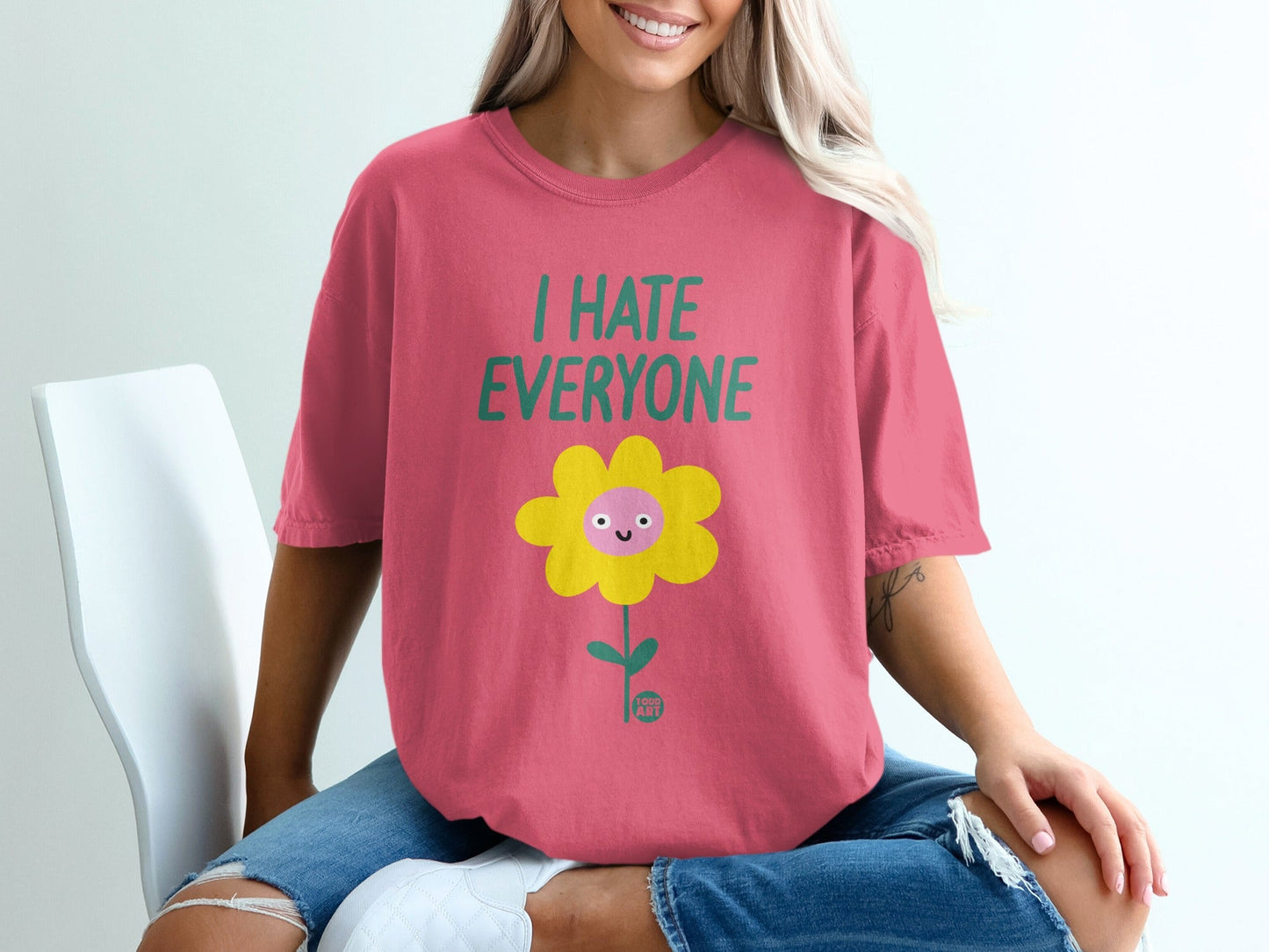 Pink t-shirt with a smiling flower graphic and "I HATE EVERYONE" text.
