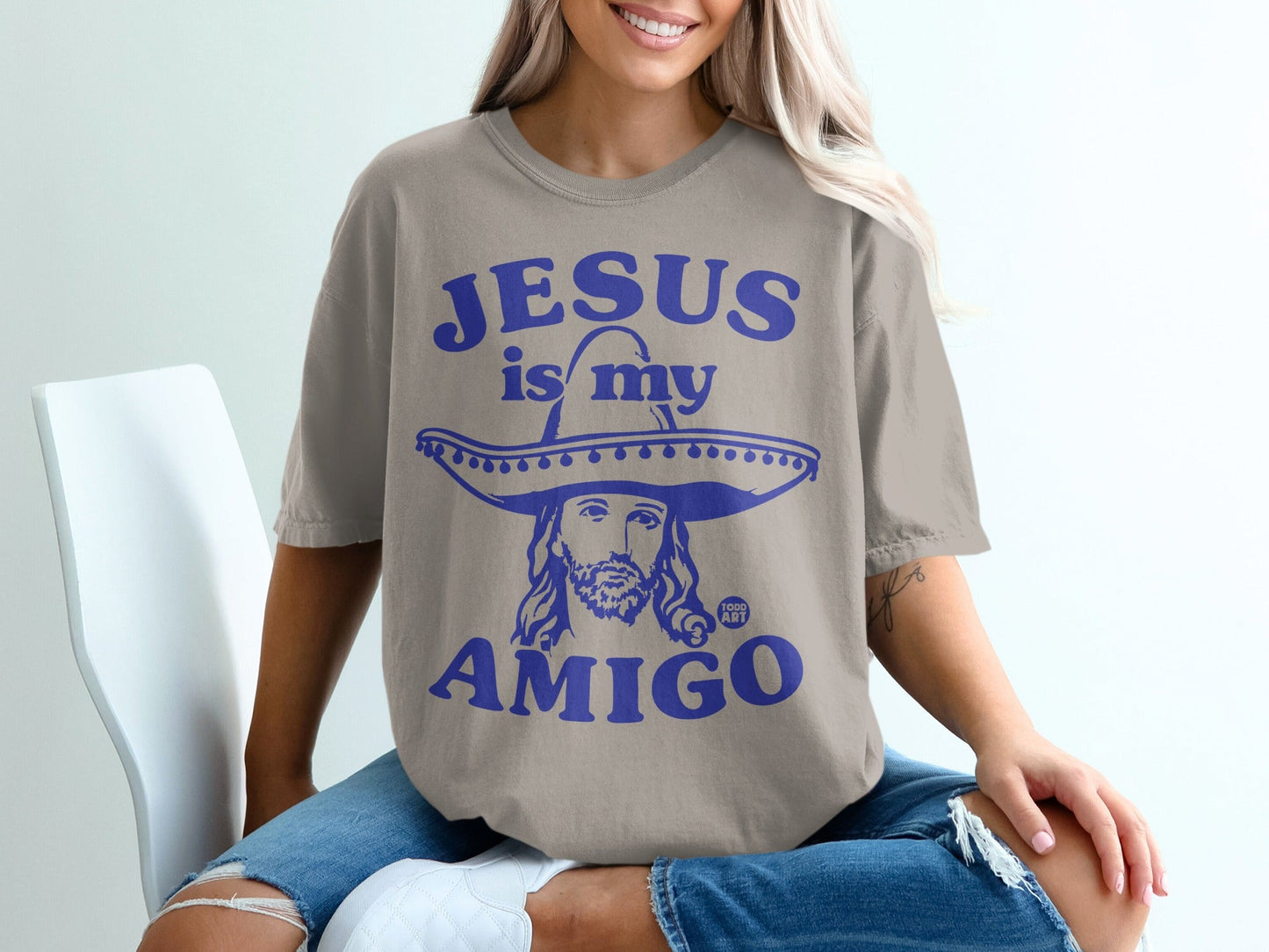 T-shirt with "Jesus is my amigo" text and graphic of Jesus wearing a sombrero.
