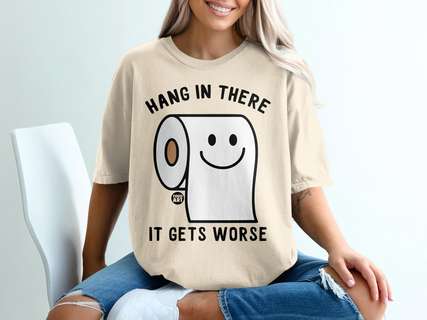 T-shirt with toilet paper character, text "Hang in there it gets worse".