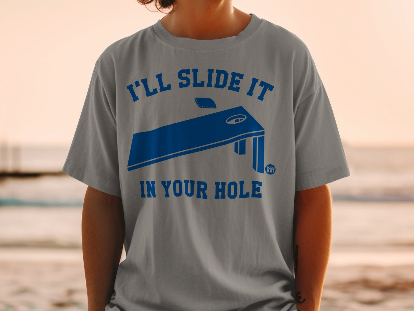 Cornhole board graphic with text "I'll slide it in your hole".
