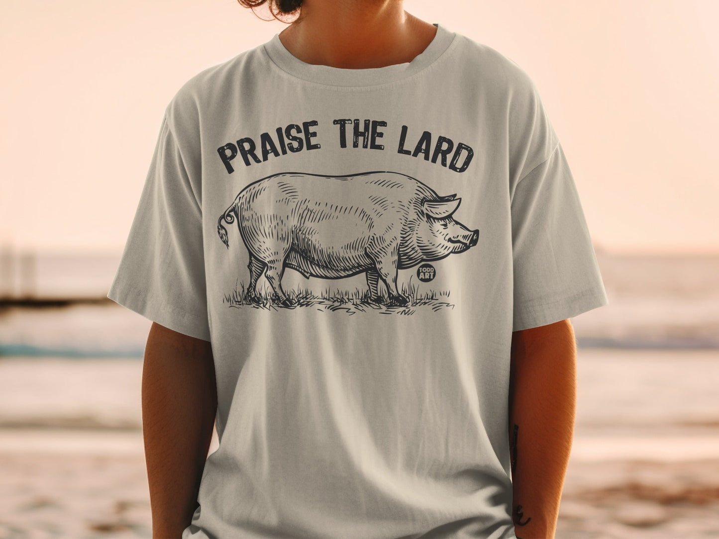 T-shirt with sketch of a pig and text "Praise the Lard".